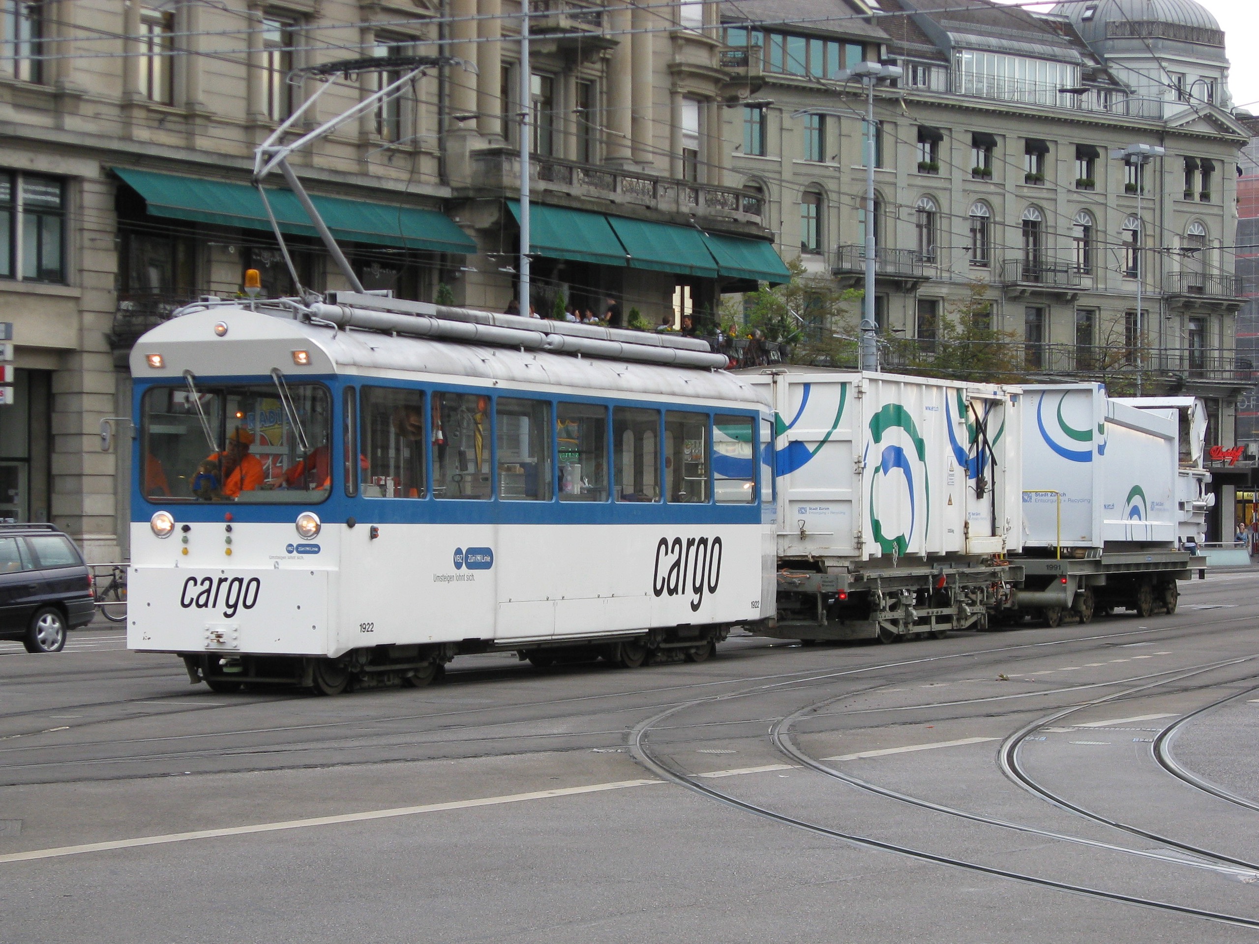 a white tram on a road