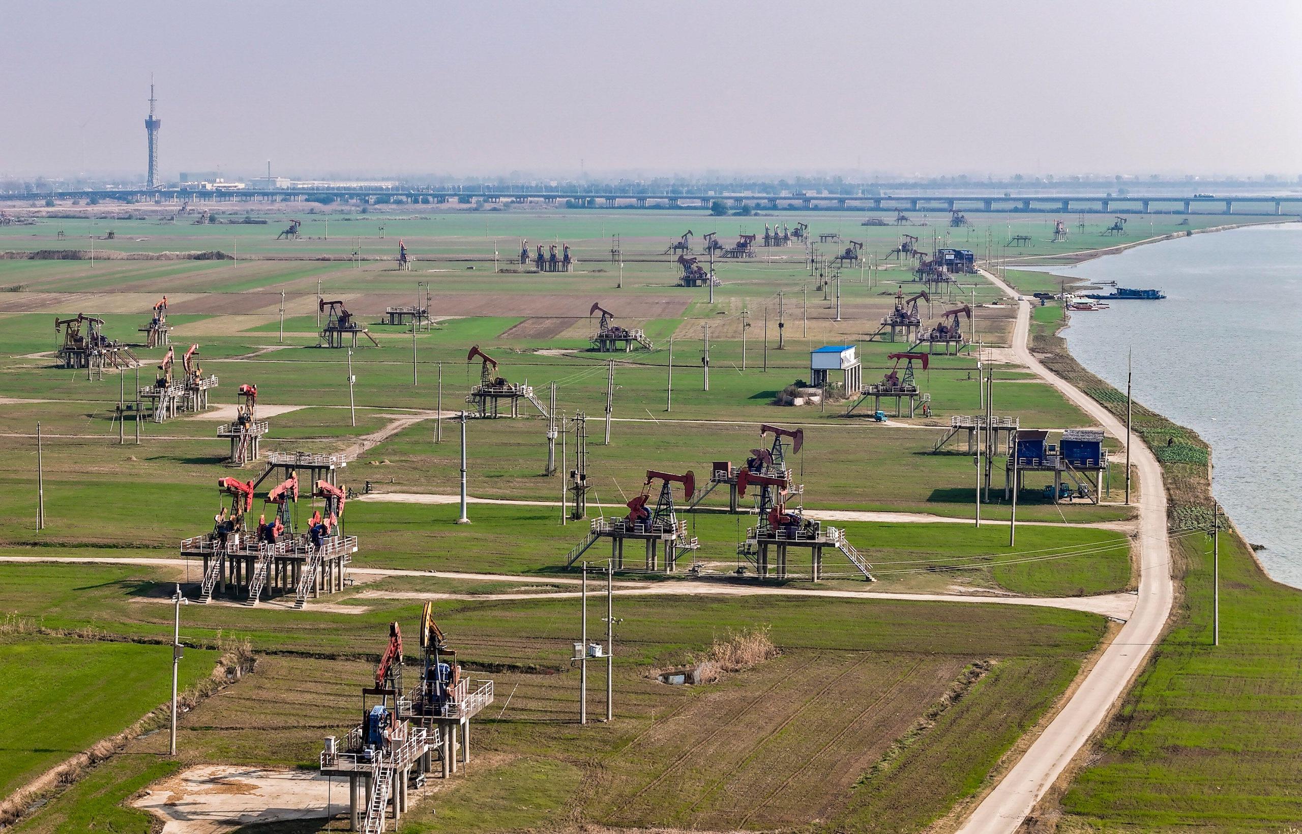Oil field dotted with oil drilling towers