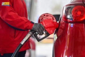 Filling up a red car at the petrol pump