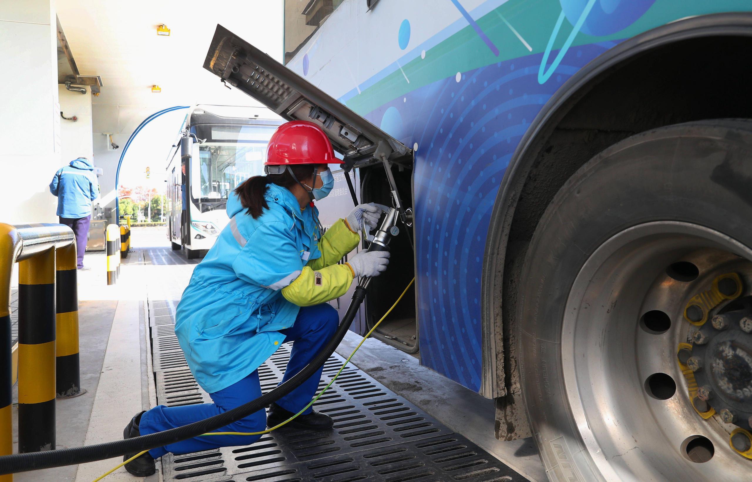 Filling up a bus with a fuel pipe