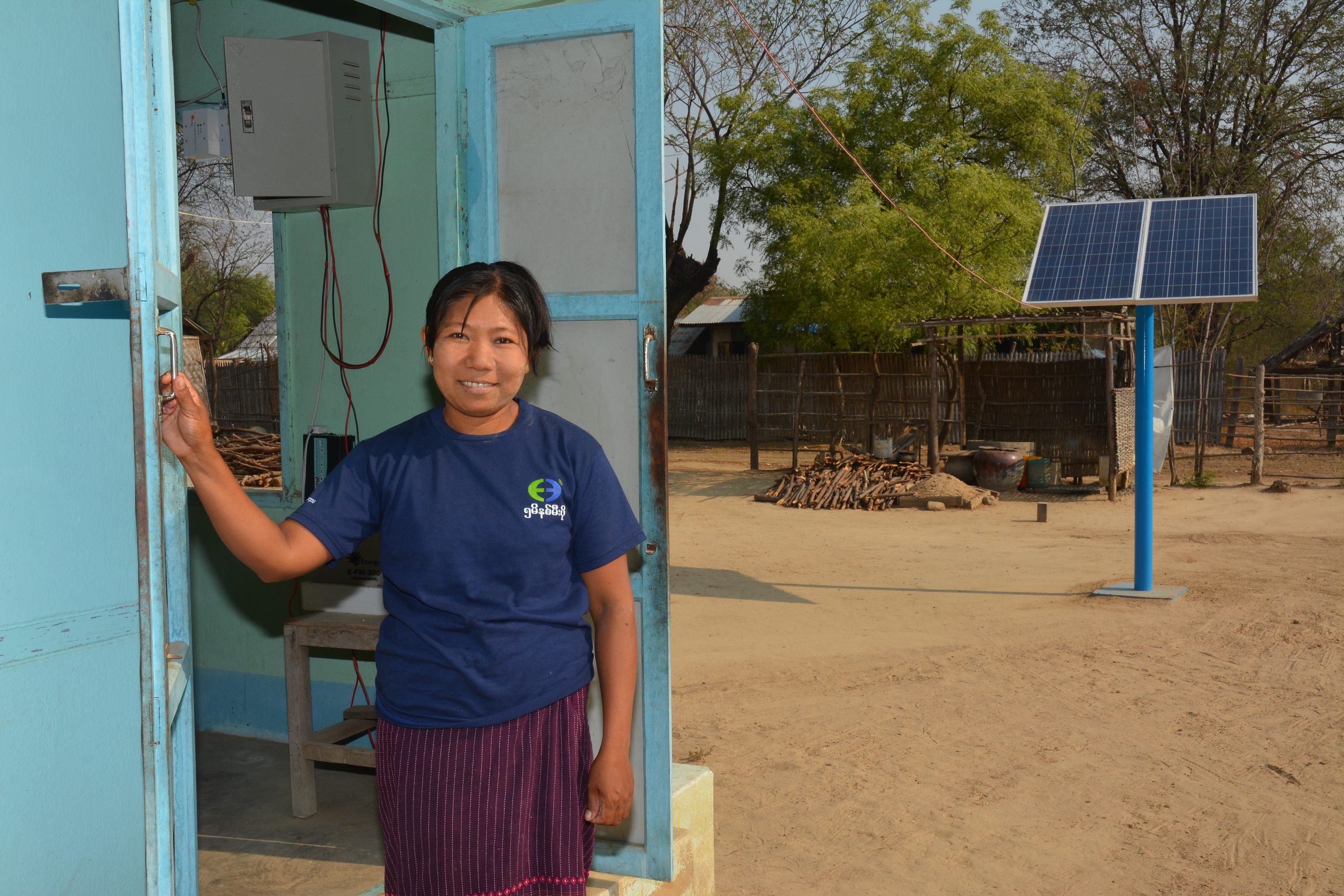 smiling lady posing with solar array