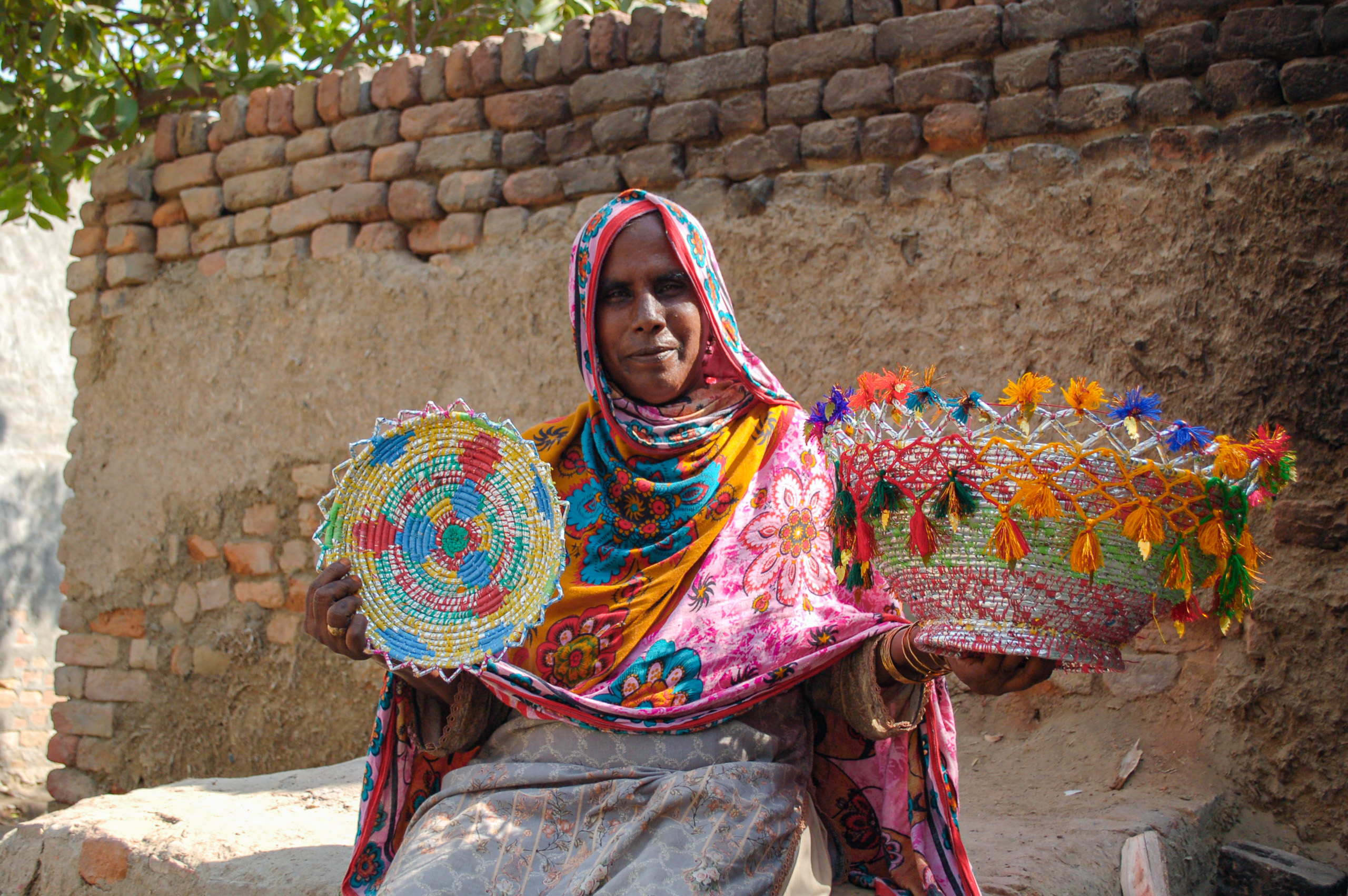 Woman holding colourful woven baskets