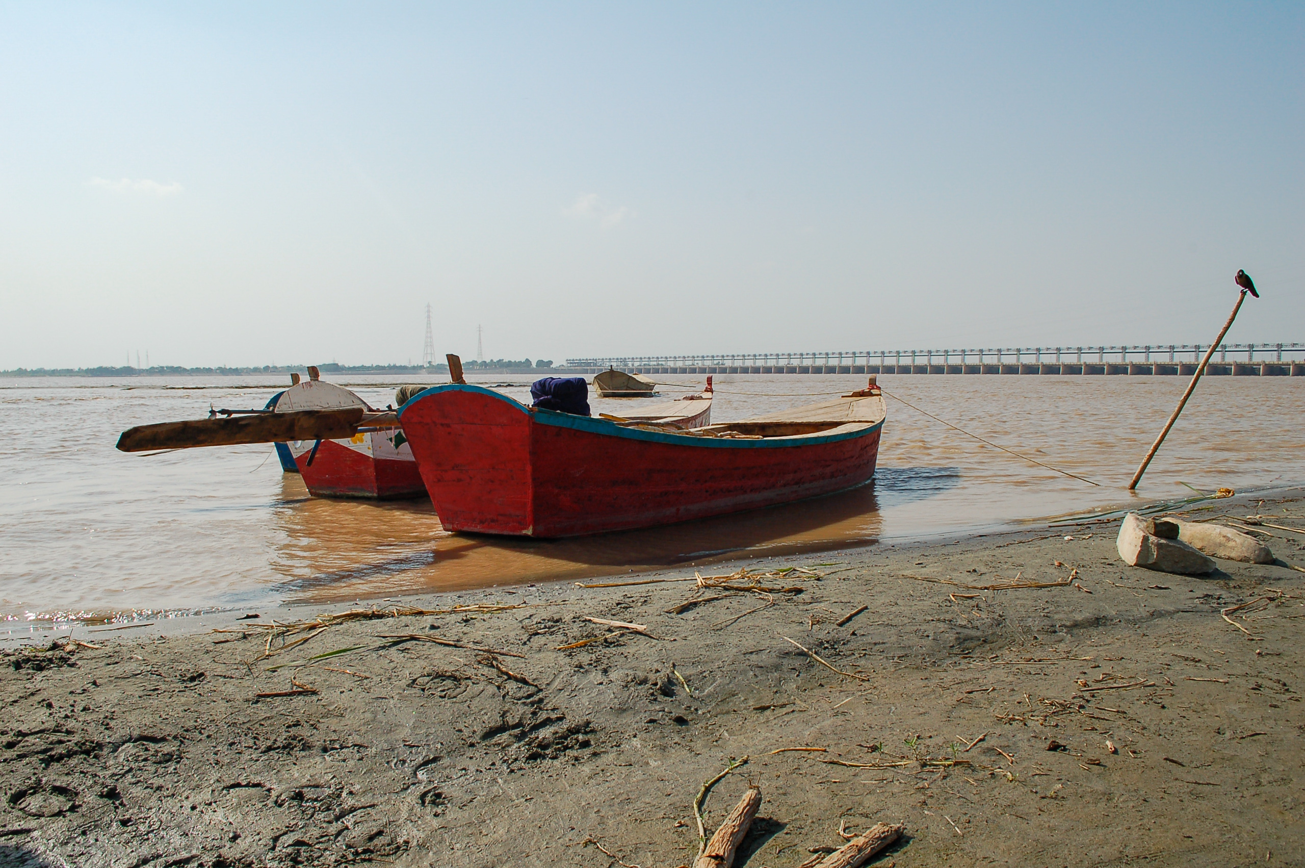 Boats on the banks of a muddy river