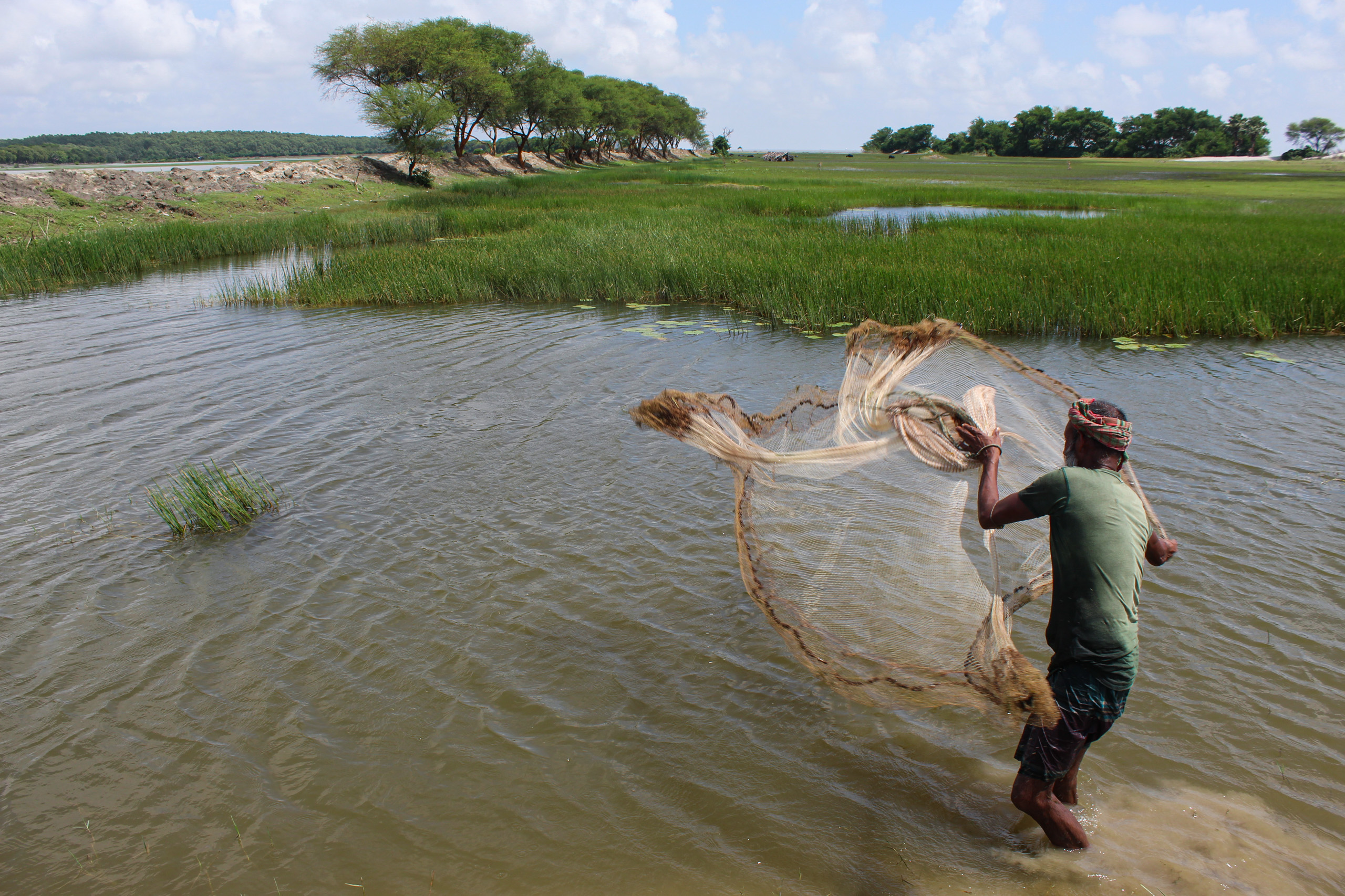 man throwing fishing net