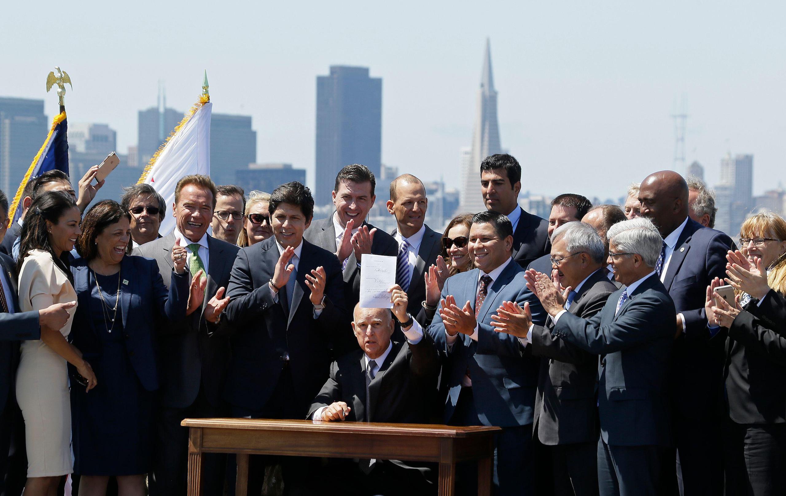 a man holding a piece of paper surrounded by a group of people