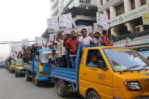 a group of people on a truck carrying posters