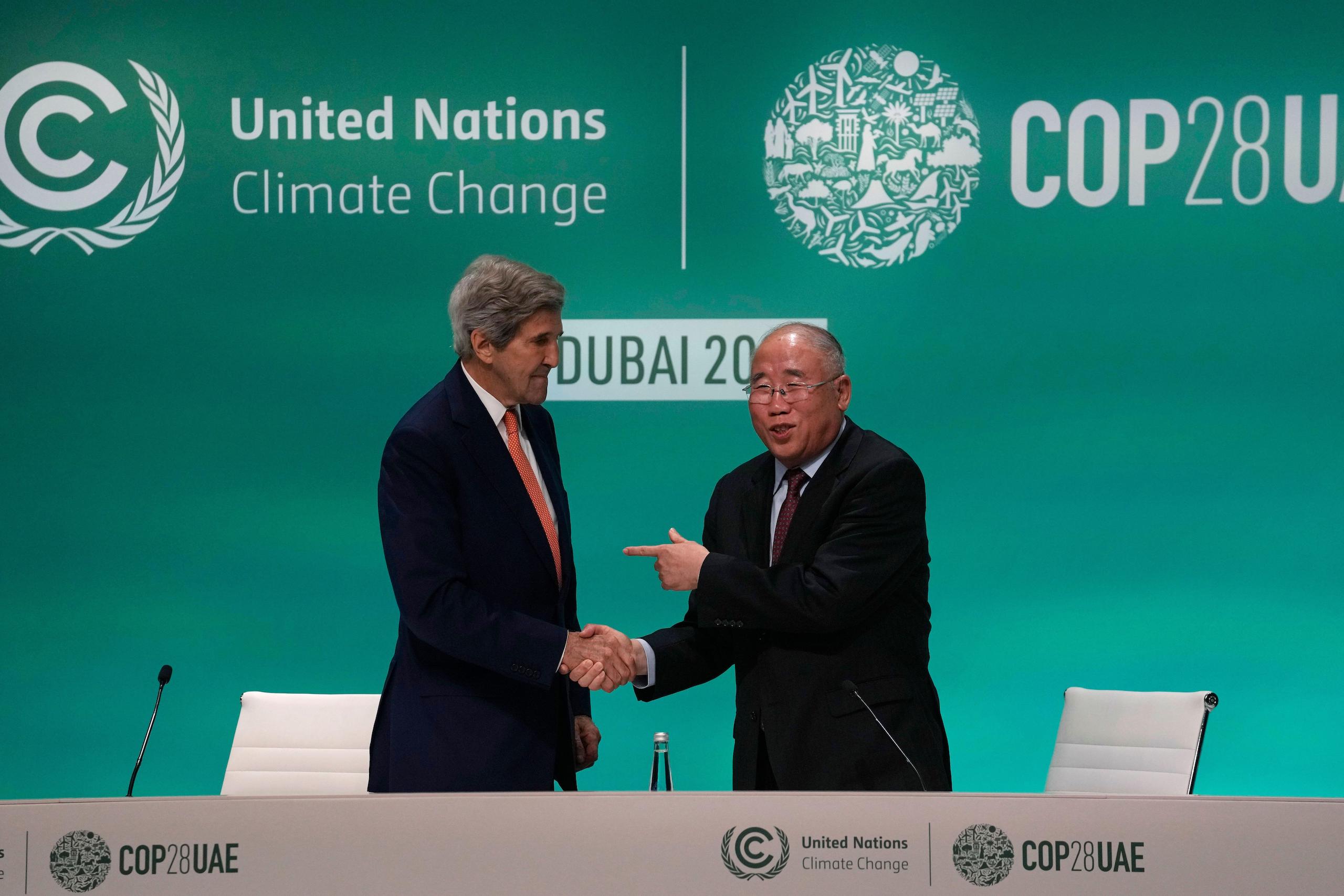 John Kerry and Xie Zhenhua men shaking hands at COP28