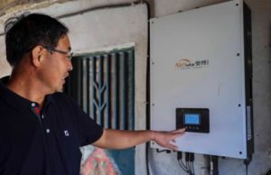 <p>A Qingdao homeowner checks how much electricity has been generated by solar panels on his roof in eastern China (Image: Han Jiajun / Alamy)</p>