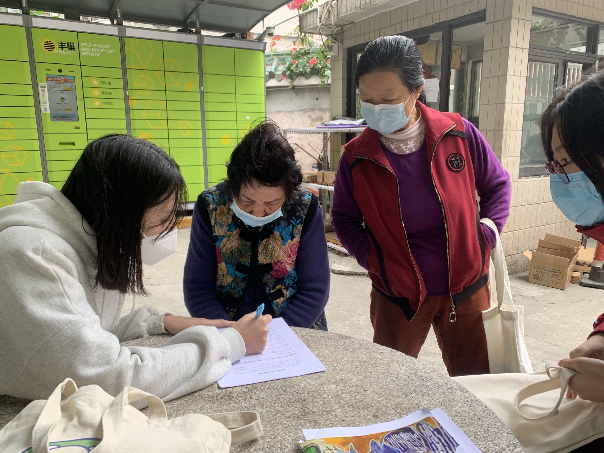 a group of people wearing face masks filling a survey