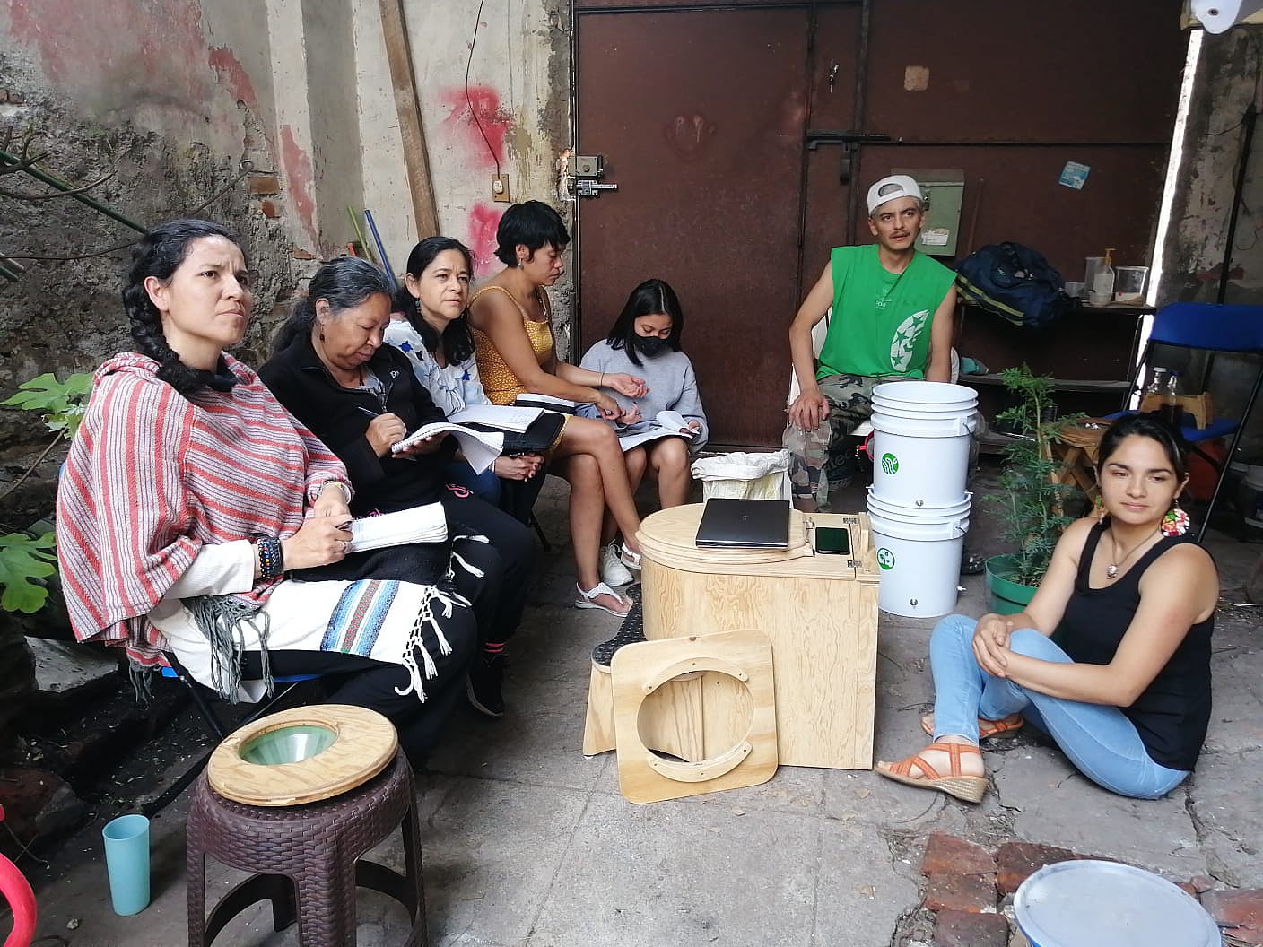 a group of people sitting in a workshop
