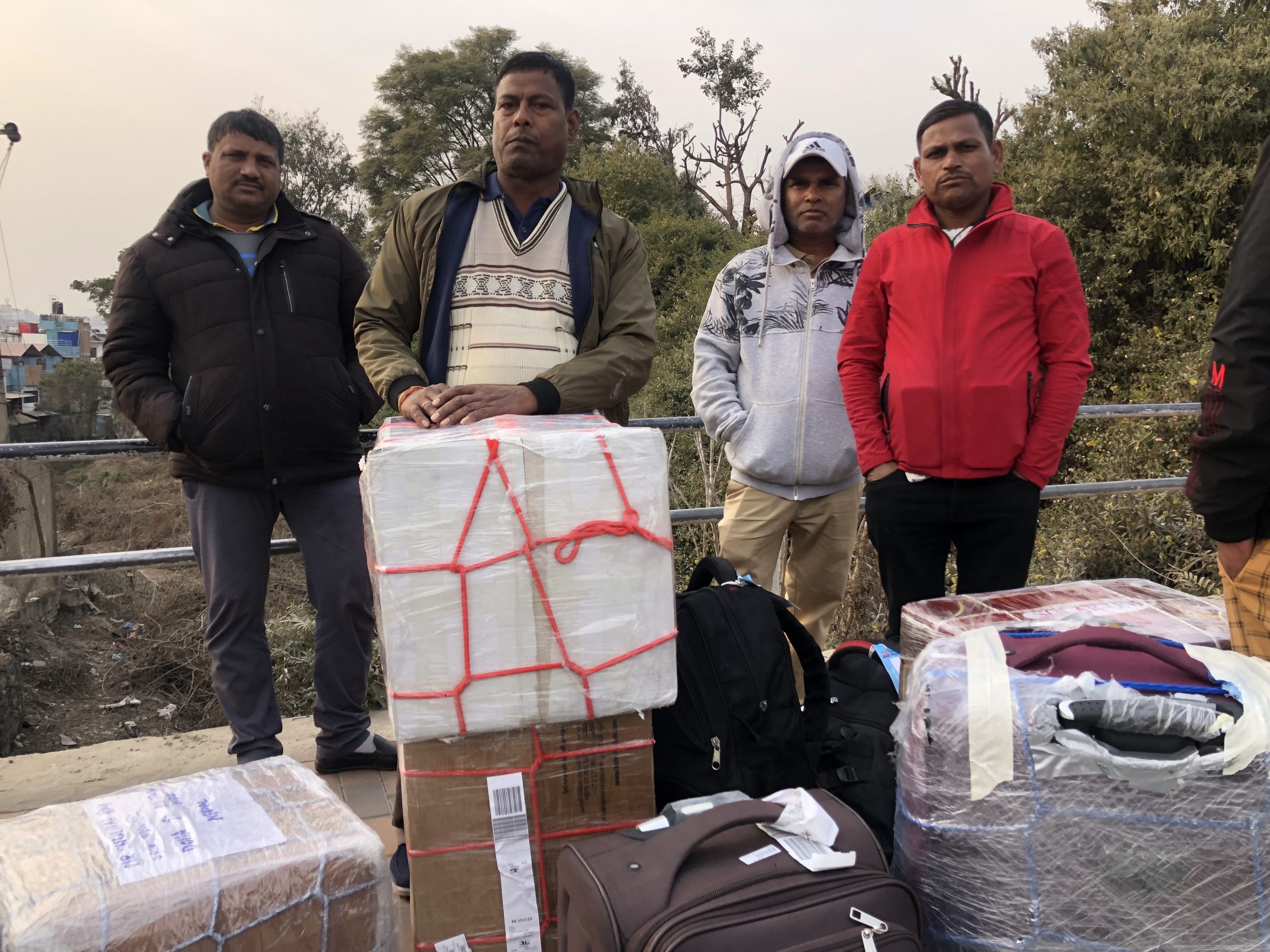 group of men with luggage