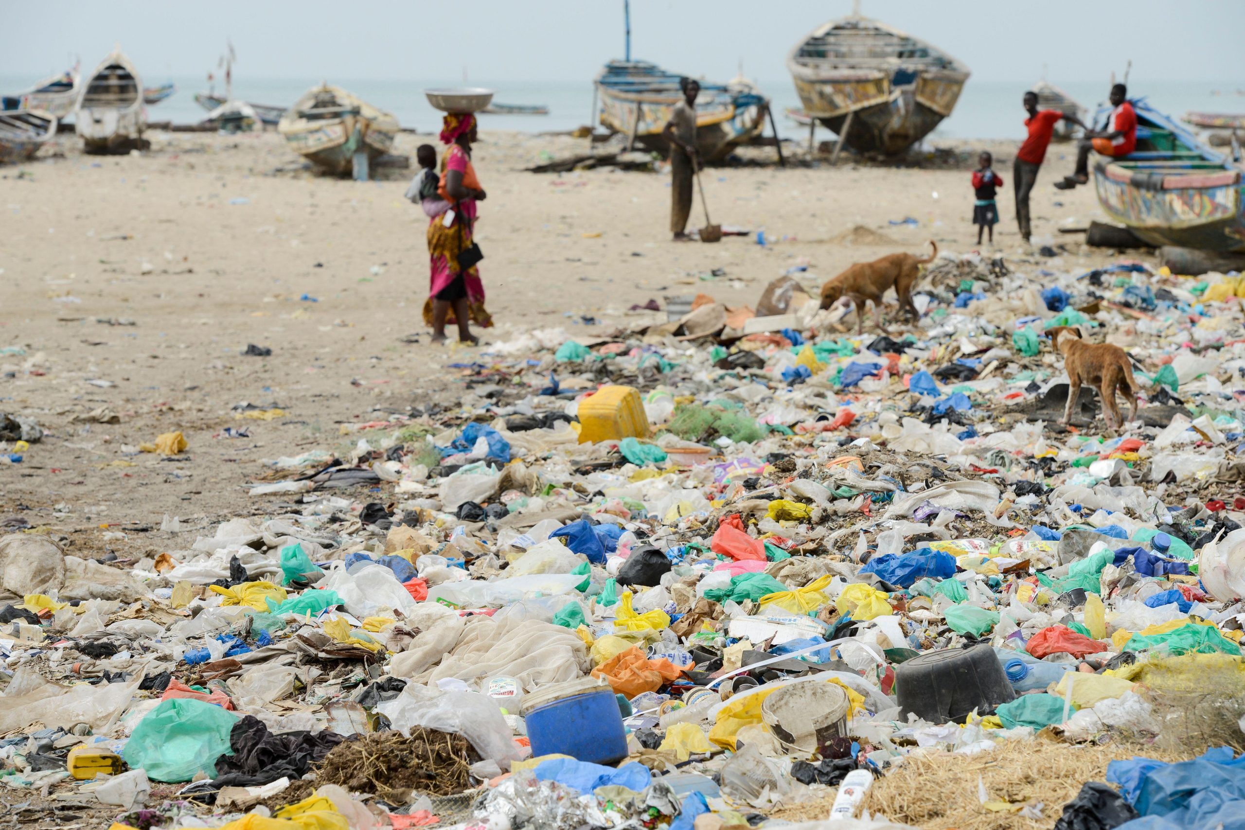 <p>一群渔民在塞内加尔一处污染严重的海滩上。图片来源：乔格·波特林/Alamy</p>