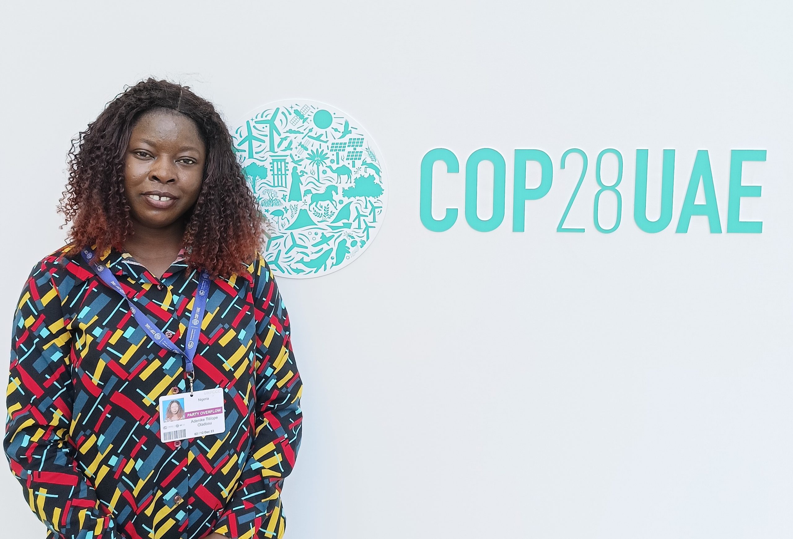 Oladosu Adenike standing in front of a board at COP28