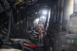 A coal mine worker in a tunnel