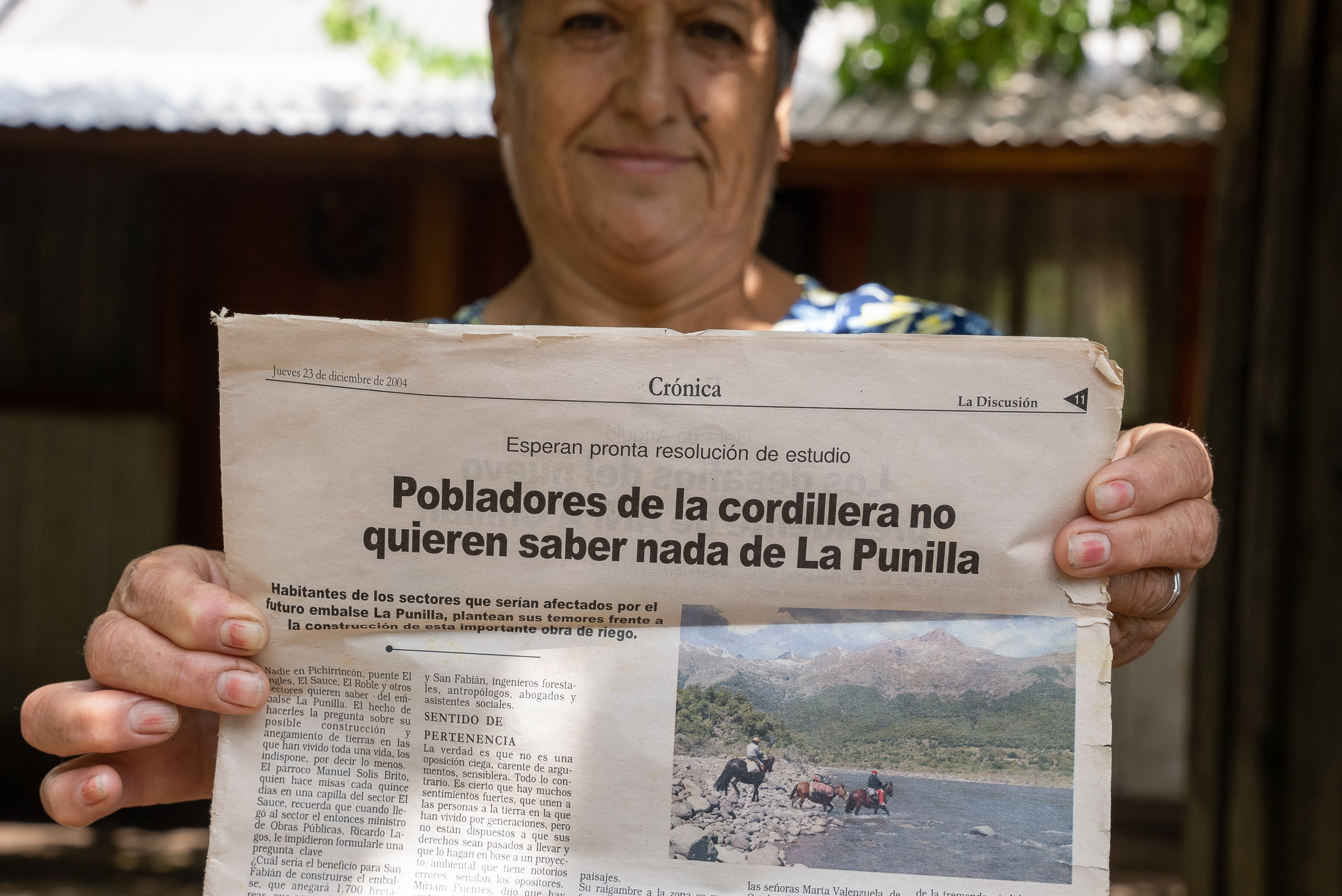 woman holding up newspaper
