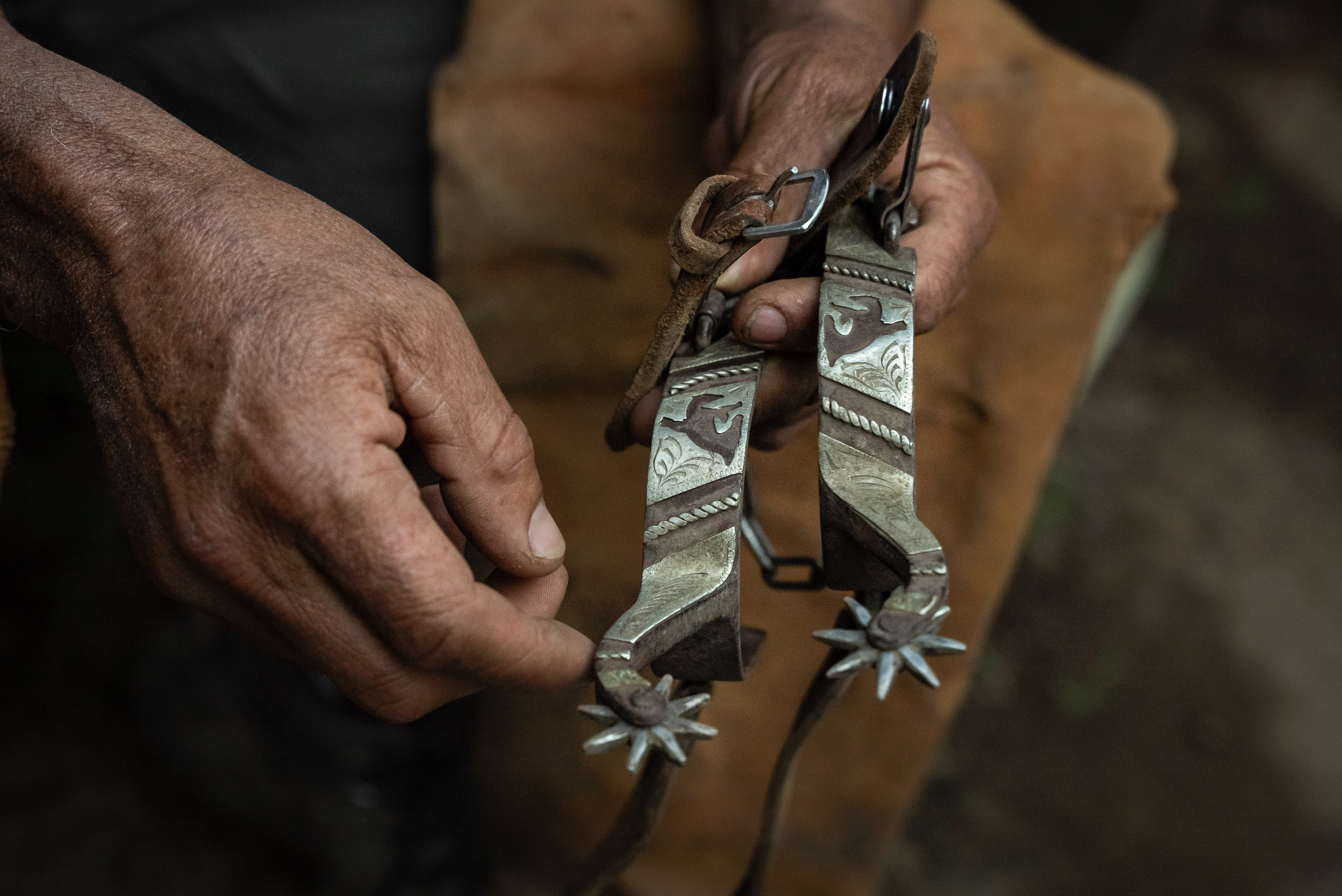 closeup of hands holding spurs