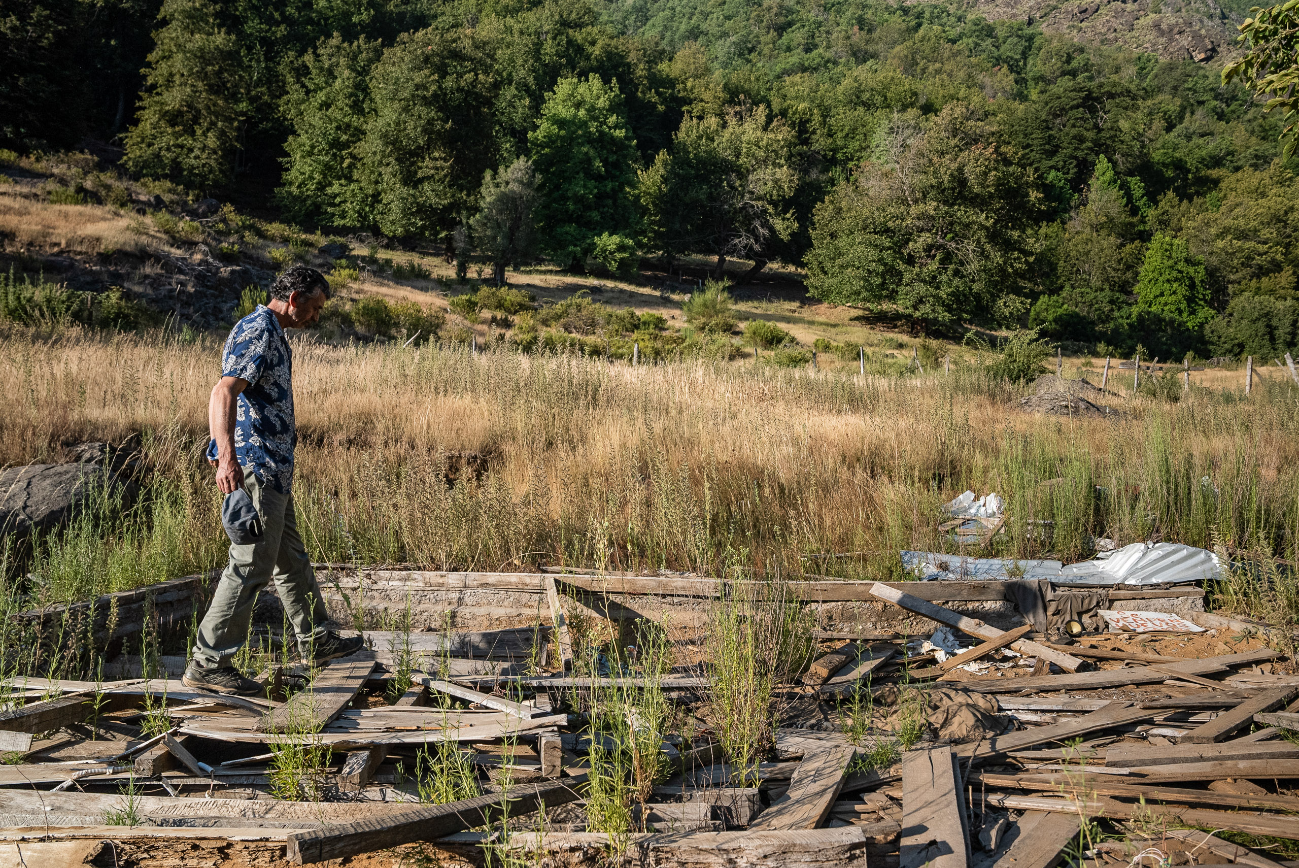 man walking through rubble