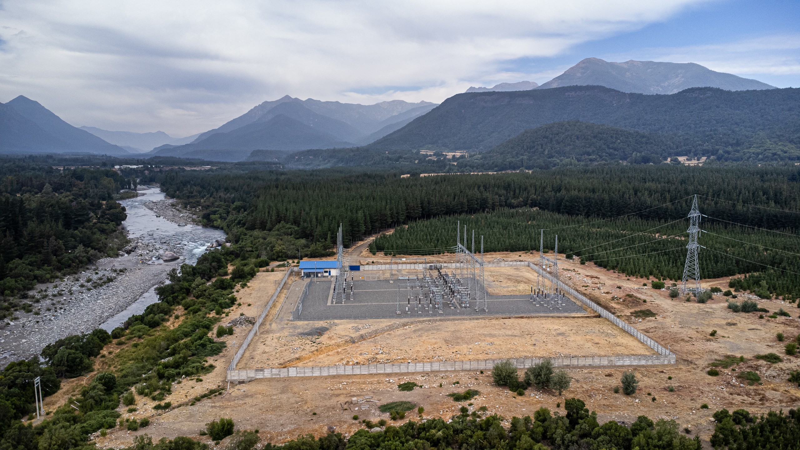 electric substation in cleared area of forest next to river