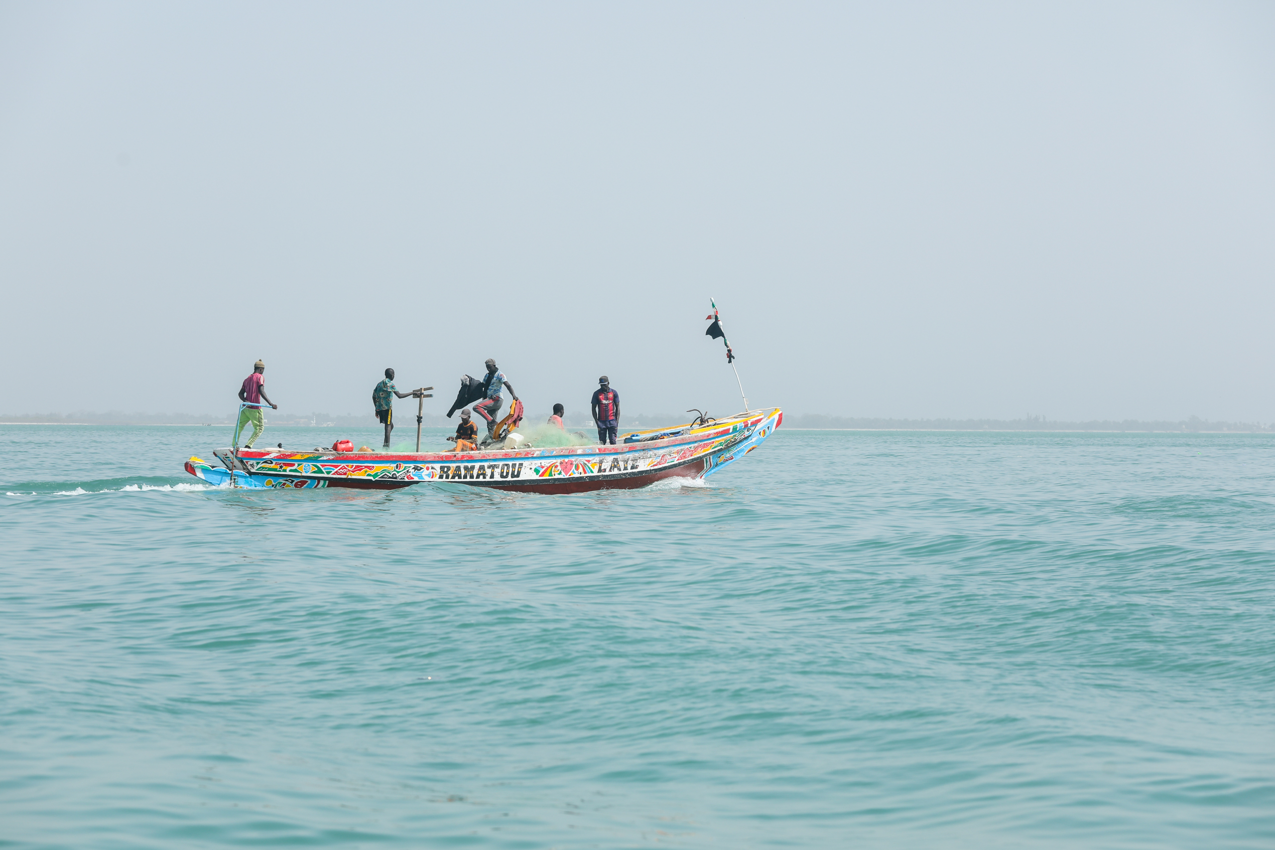 people on small motor boat