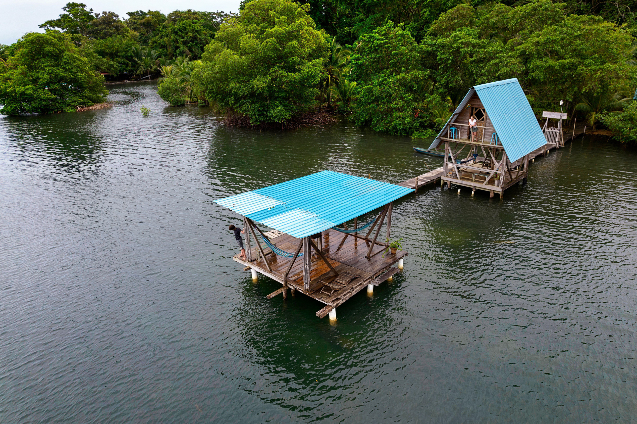 wooden cabins on stilts in dark water