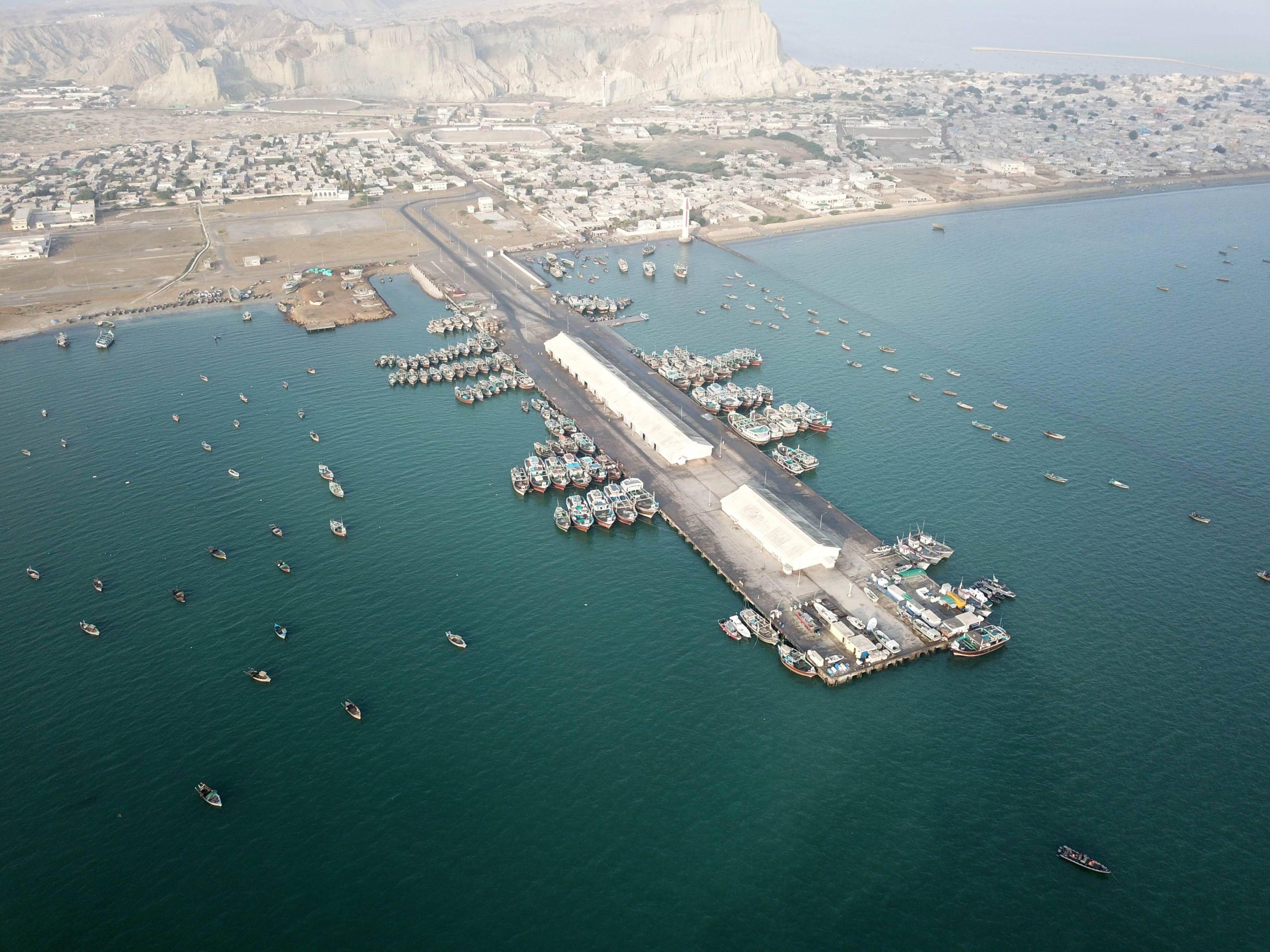 <p>An aerial view of Gwadar port shows fishing boats in the bay in southwest Pakistan. (Image: Ahmad Kamal / Alamy)</p>