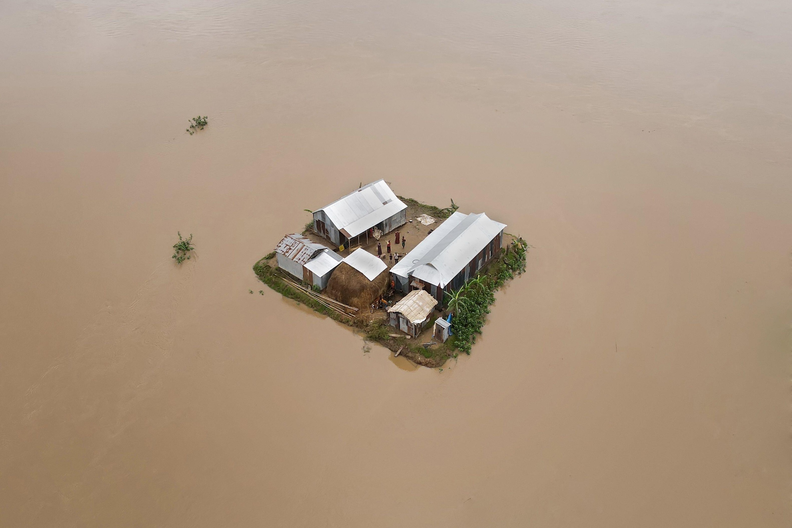 <p>A house surrounded by floodwater in Sunamganj, northeast Bangladesh. Extreme heavy rain in spring 2022 <a href="https://reliefweb.int/report/bangladesh/bangladesh-floods-final-report-mdrbd028#:~:text=Later%2C%20in%20June,by%20this%20flood.">submerged 94% of the district</a>, which sits on the border with India. (Image: Muhammad Amdad Hossain / Alamy)</p>