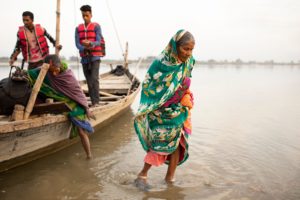 <p>Women are evacuated by boat from a flooded area on the India-Nepal border (Image: Jake Lyell / Alamy)</p>