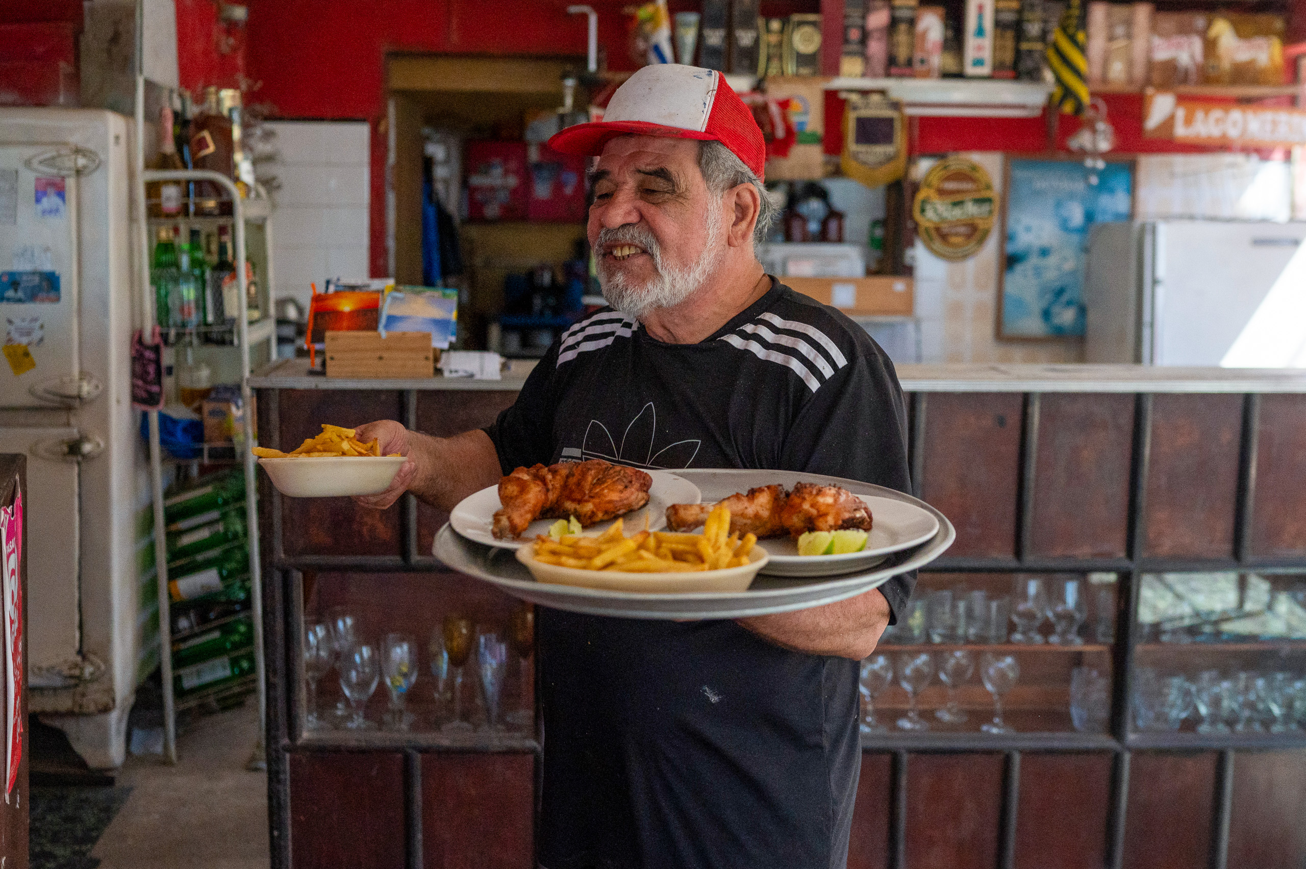 man holding plates of food in each hand