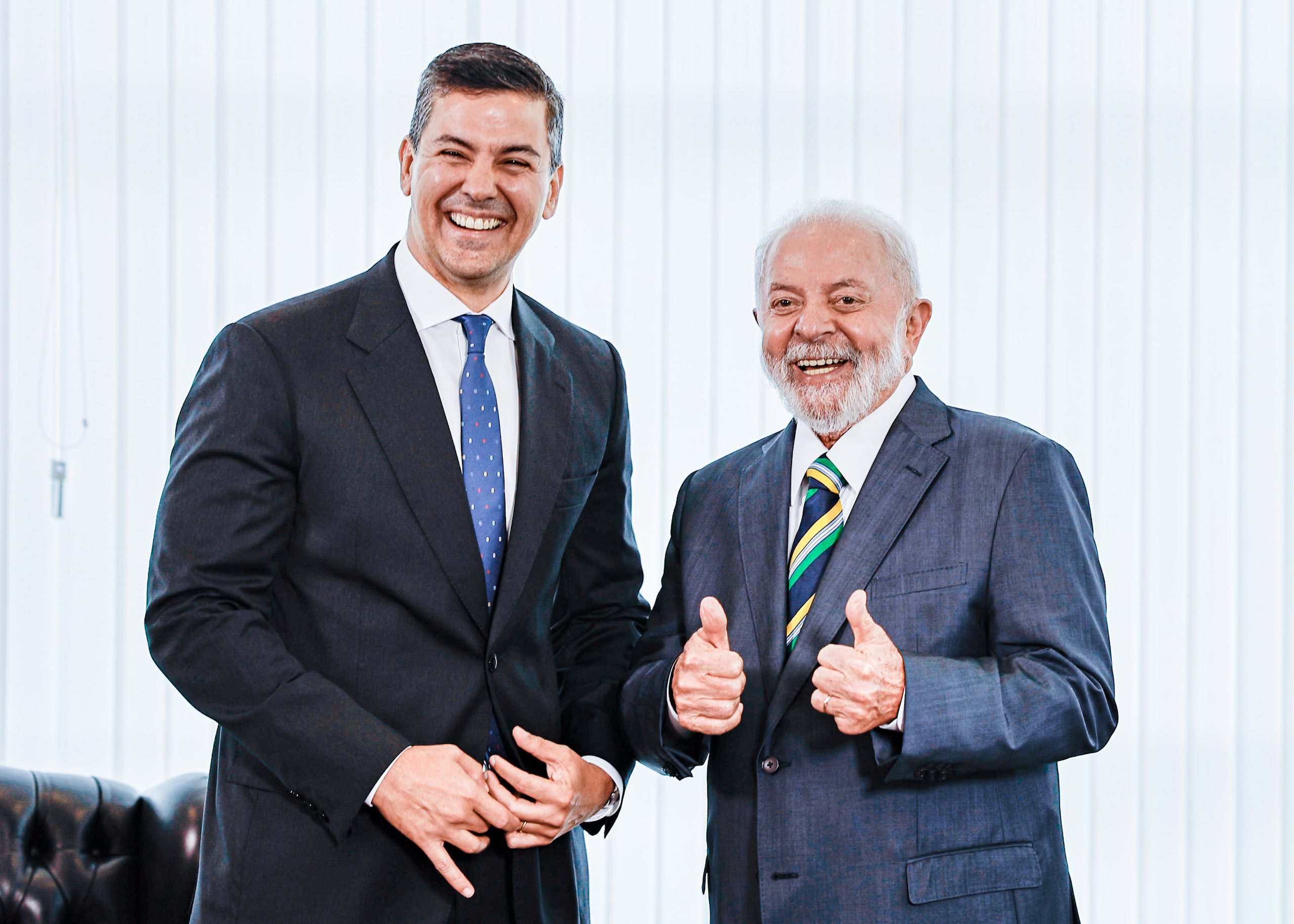 Two men in suits standing next to each other