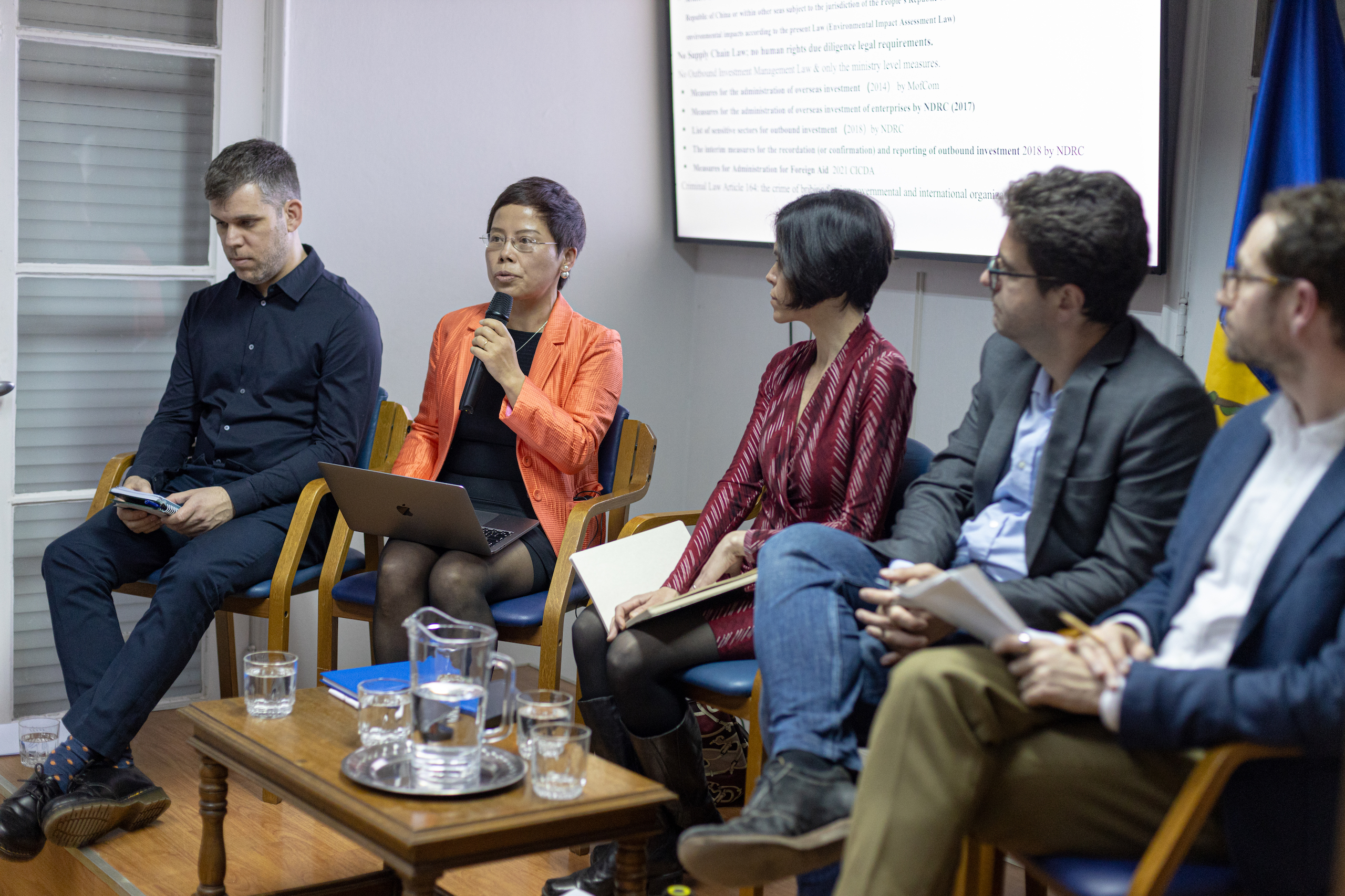 A diverse group engaged in conversation while seated on chairs