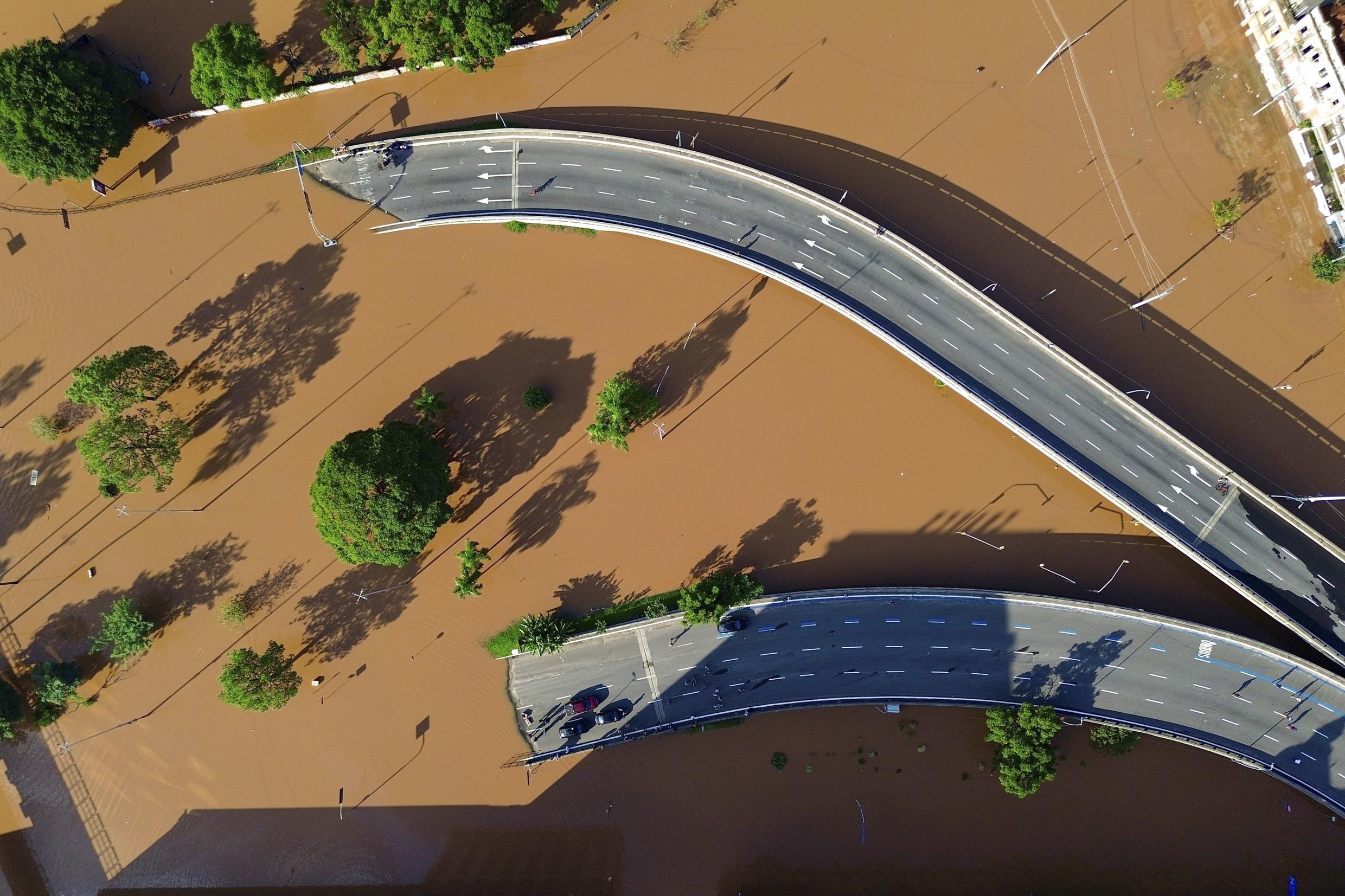 An aerial view of a flooded road and bridge