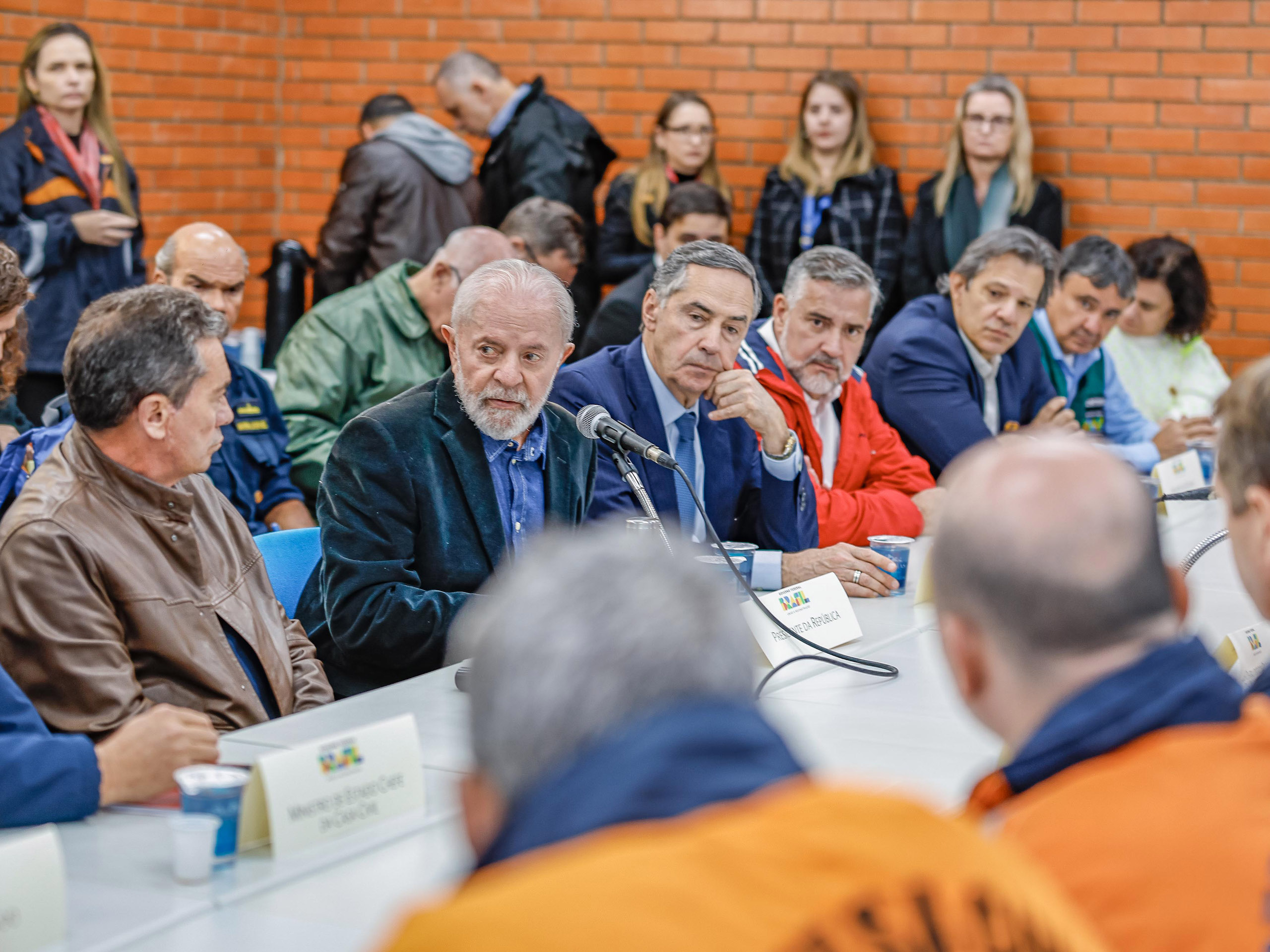 Brazil president Lula sitting with a panel of men, engaged in a discussion