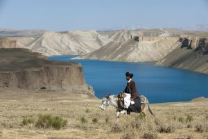 A man riding a horse in the mountain area