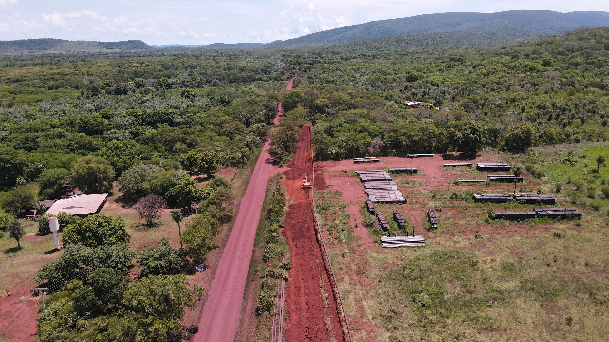 Aerial view of road winding through lush forest