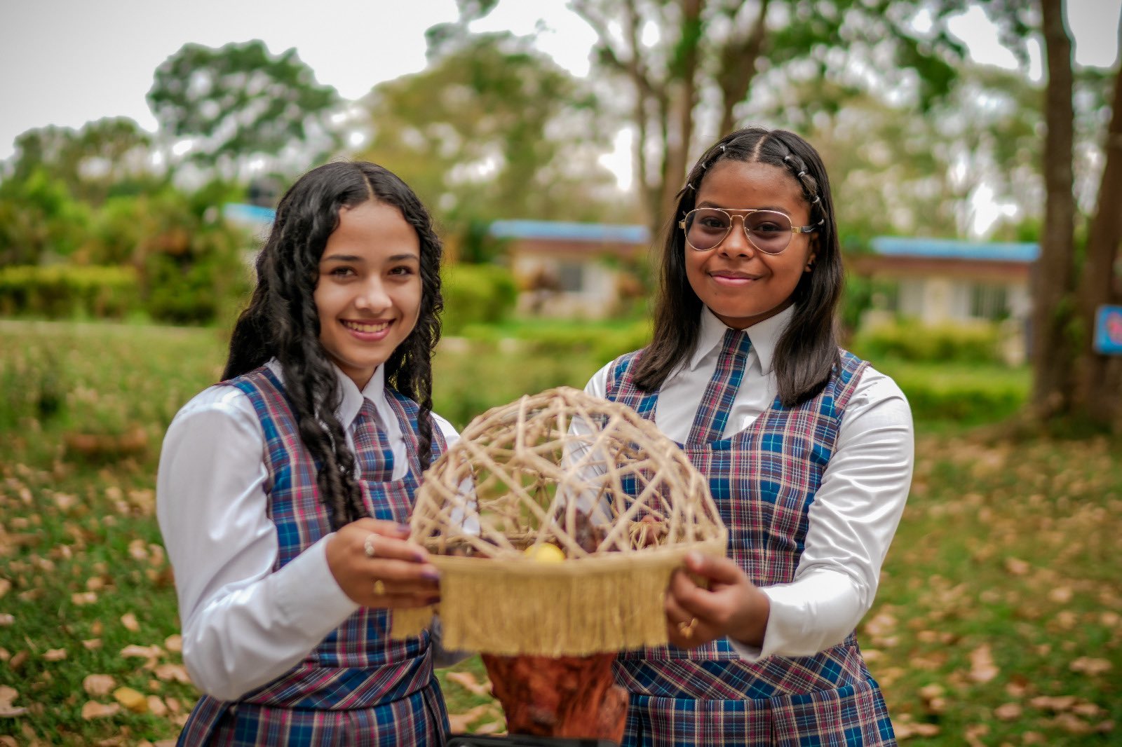 two smiling girls holding basket