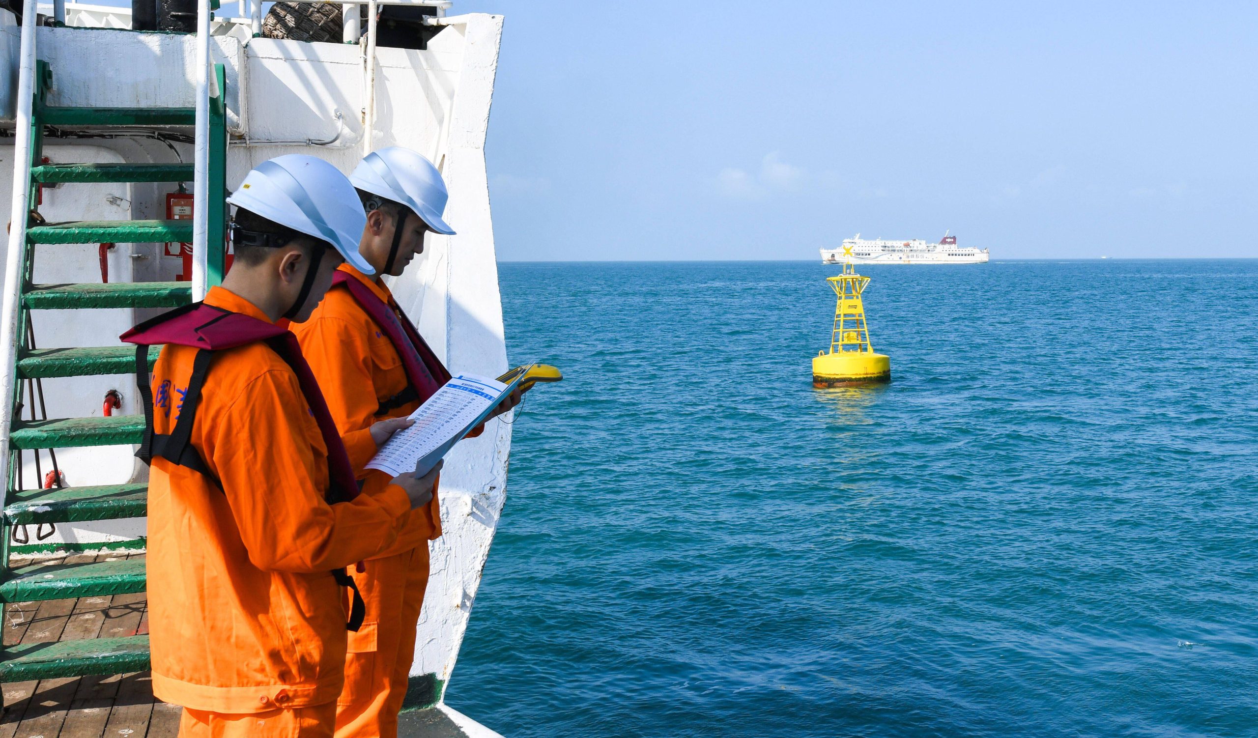 <p>Inspectors in southern China&#8217;s Qiongzhou Strait check a buoy recently fitted with an automated boat identification unit. The state is increasingly leaning on this technology to aid illegal fishing crackdowns. (Image: Alamy)</p>