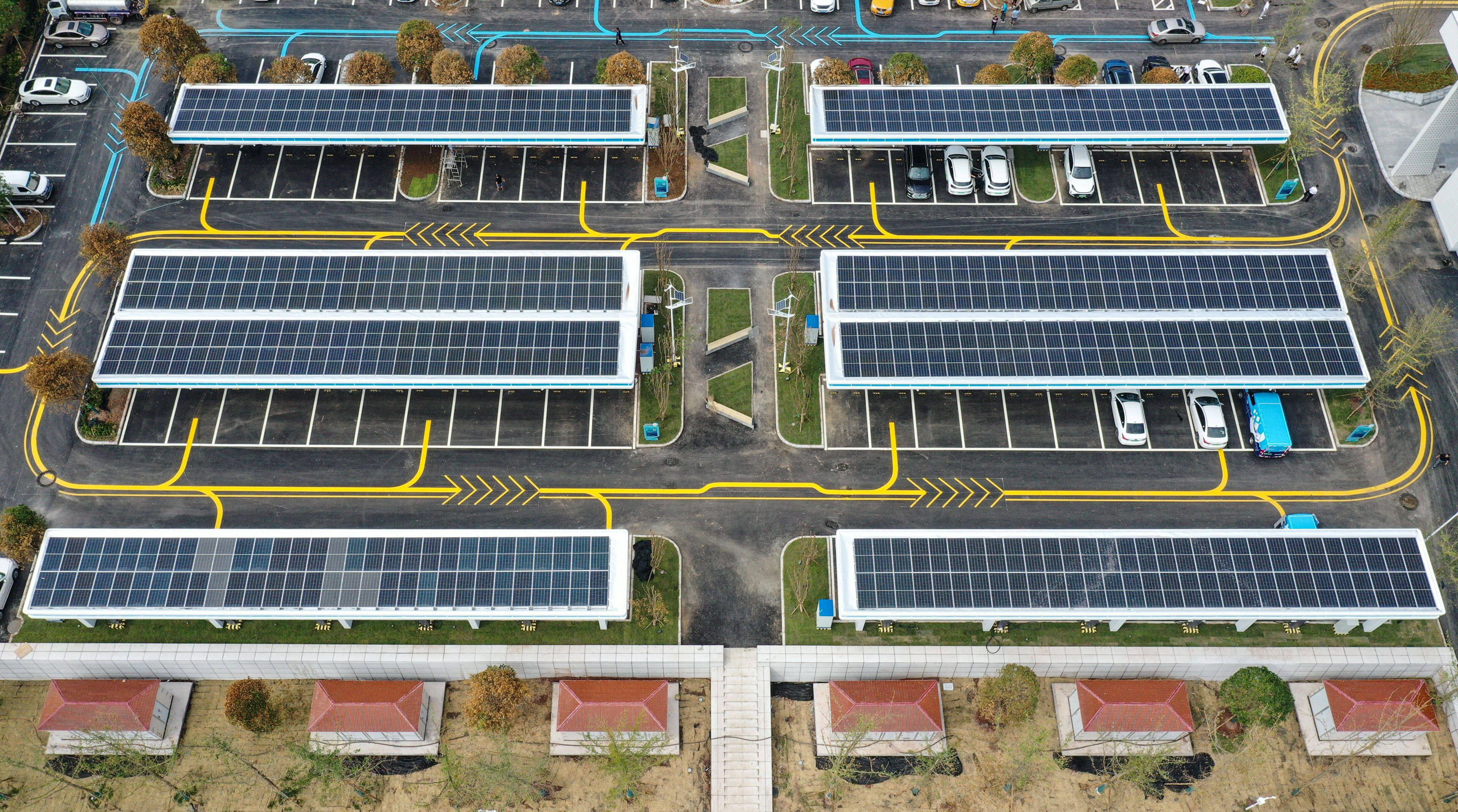 <p>A solar-powered charging station in Yibin, south-west China. Two-way charging could give vehicles like these the potential to stabilise power supplies by discharging stored electricity back to the grid. (Image: Wang Xi / Alamy)</p>