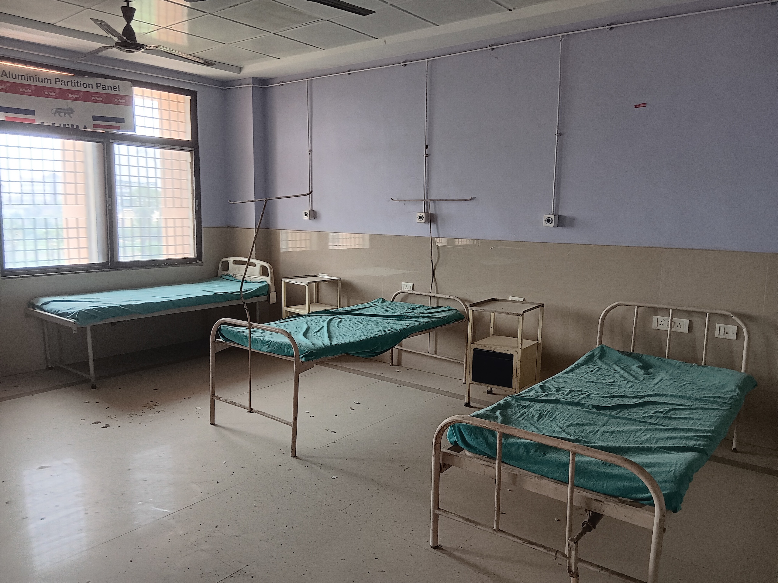 A hospital room with several beds 