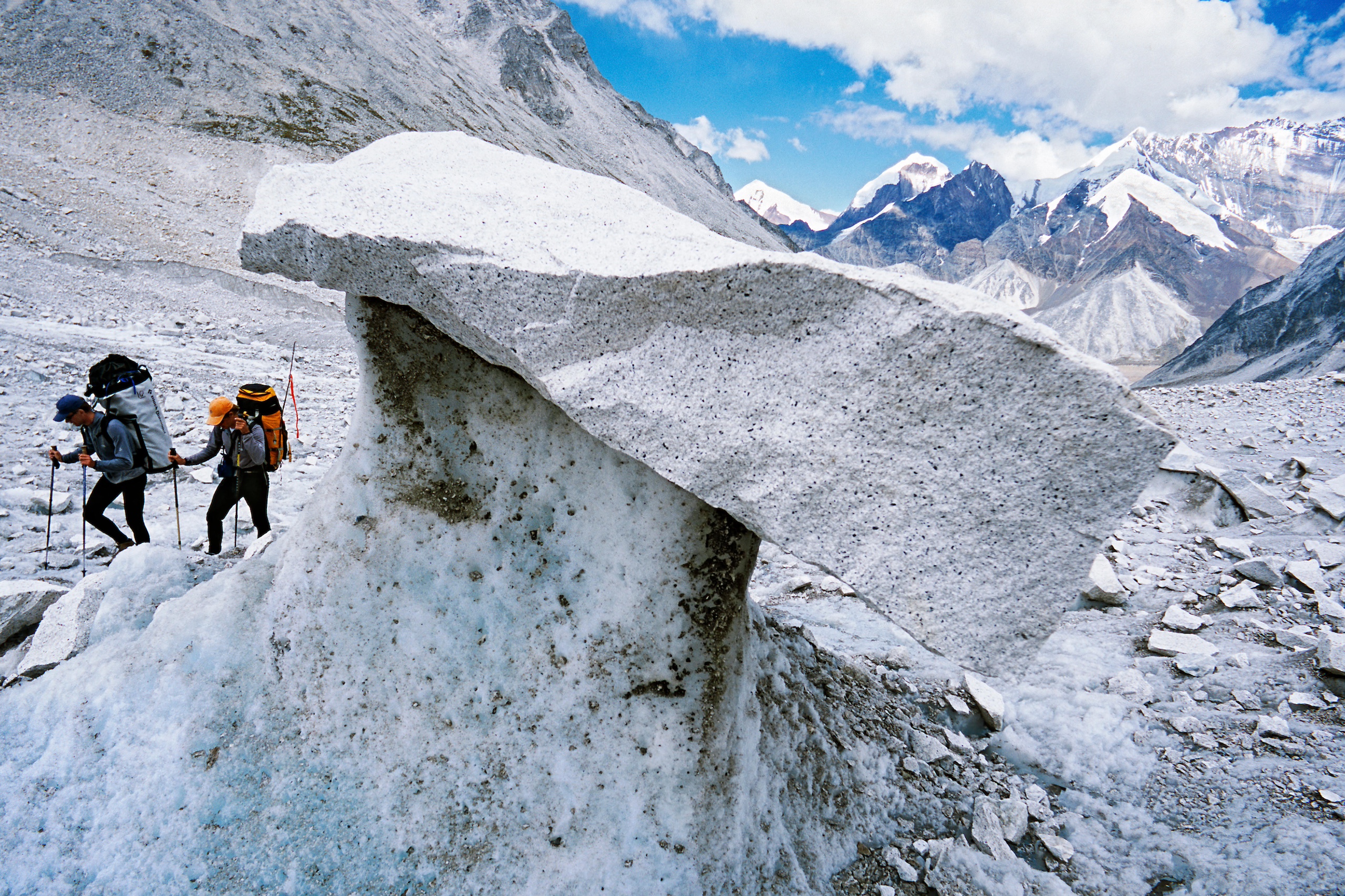 <p class="p1">Mountaineers in Garhwal, India walk past a stone table &#8211; a sign of a rapidly melting glacier. The lack of cooperation among South Asian countries to protect the frozen waters of the Himalayas leaves the region exposed and unprepared to face climate change threats. (Image: Melvin Redeker / Alamy)</p>