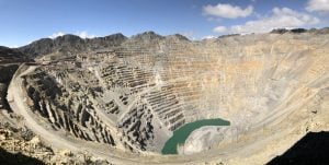 vast open pit with pool of water at base