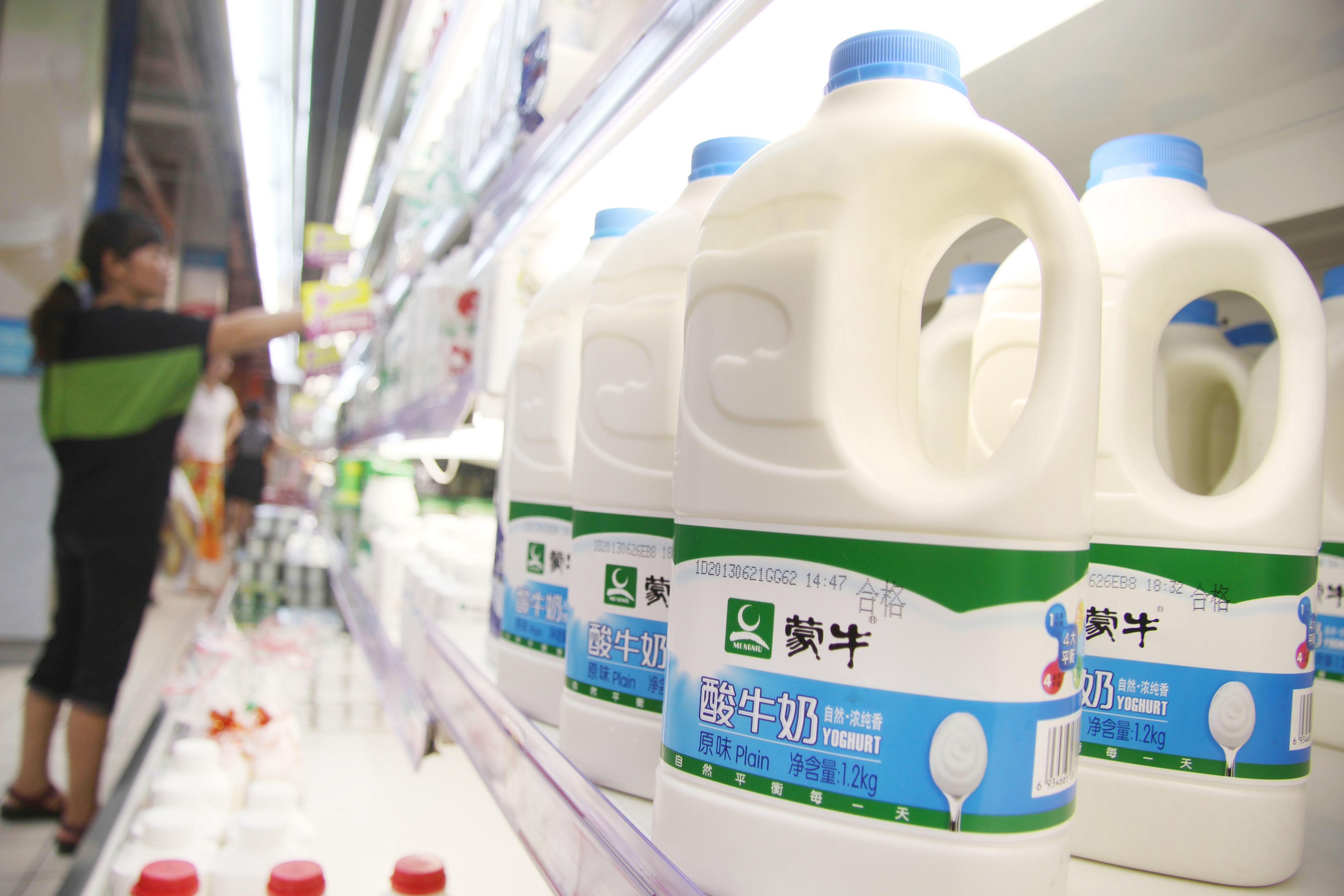 Plastic cartons of yoghurt on a supermarket shelf