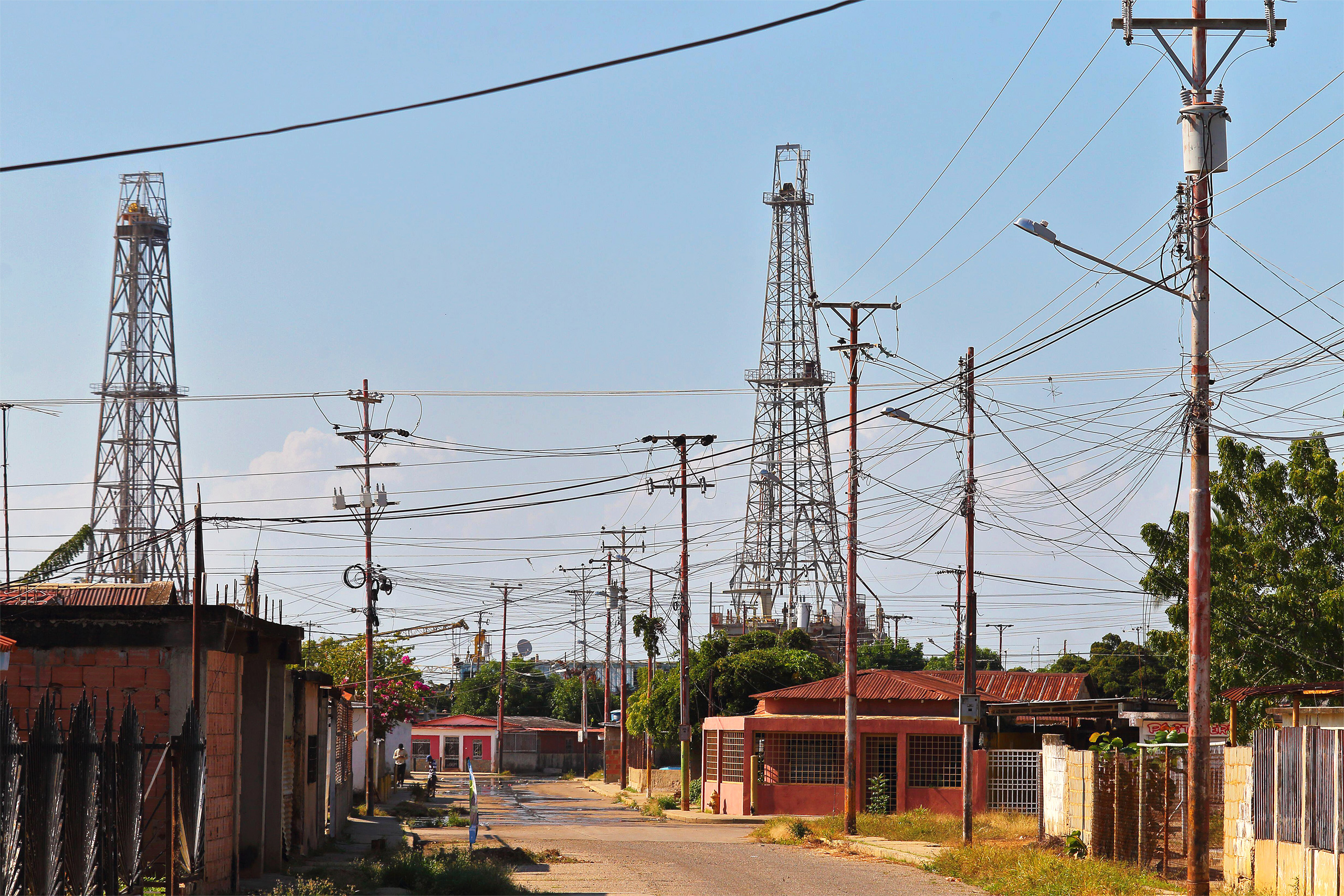 <p>Oil rigs overlook a neighbourhood in Cabimas, Zulia state, north-west Venezuela. During the 2010s, the country experienced a drop in oil production, but now the national government is looking for new partners abroad (Image: Jose Isaac Bula Urrutia / Alamy)</p>