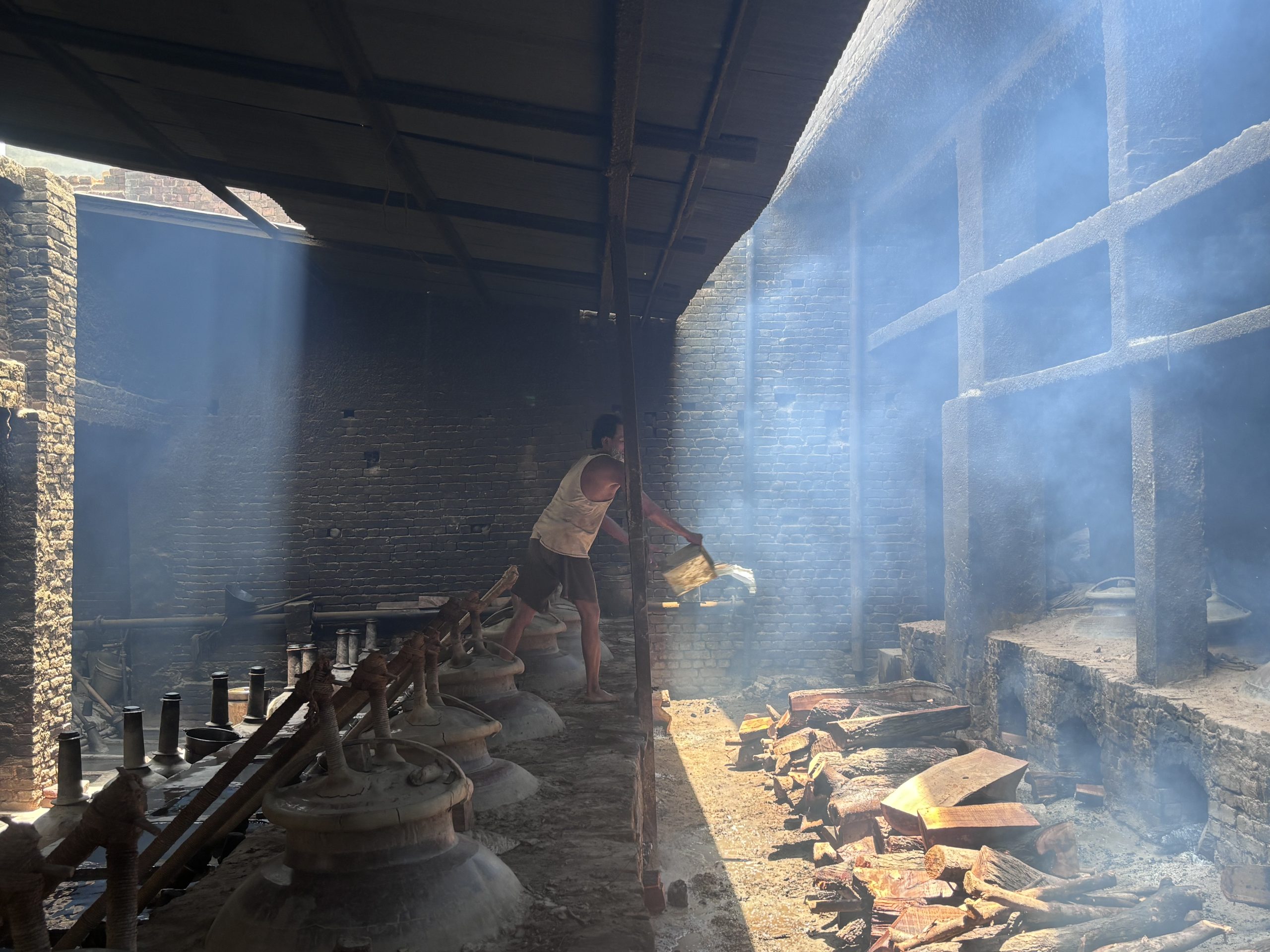 man pouring water over furnace fire