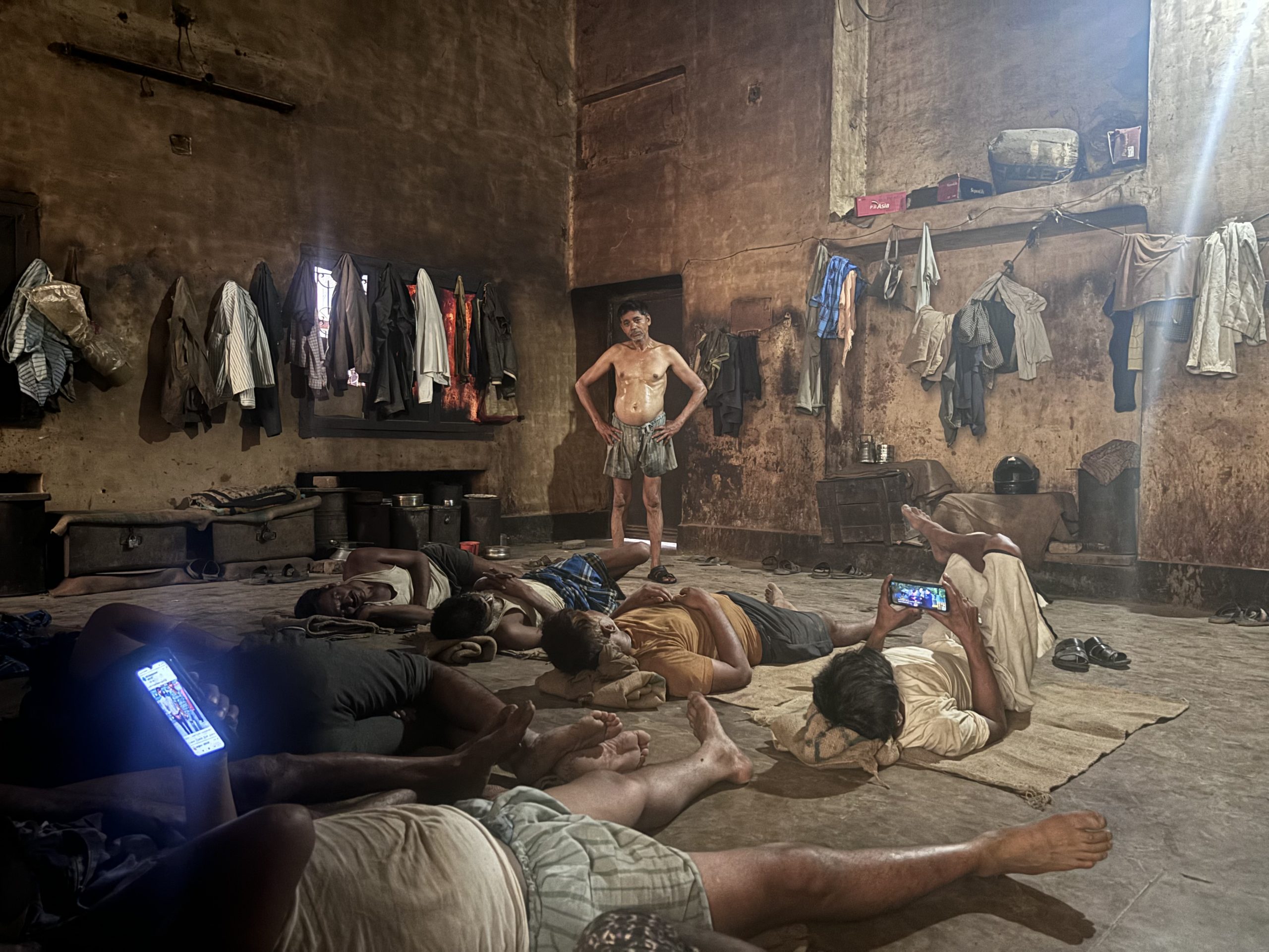 <p>Inside a perfumery in Kannauj, Uttar Pradesh, away from the heat of the furnace, workers rest during the lunch hour (Image: Tej Prakash Bhardwaj)</p>