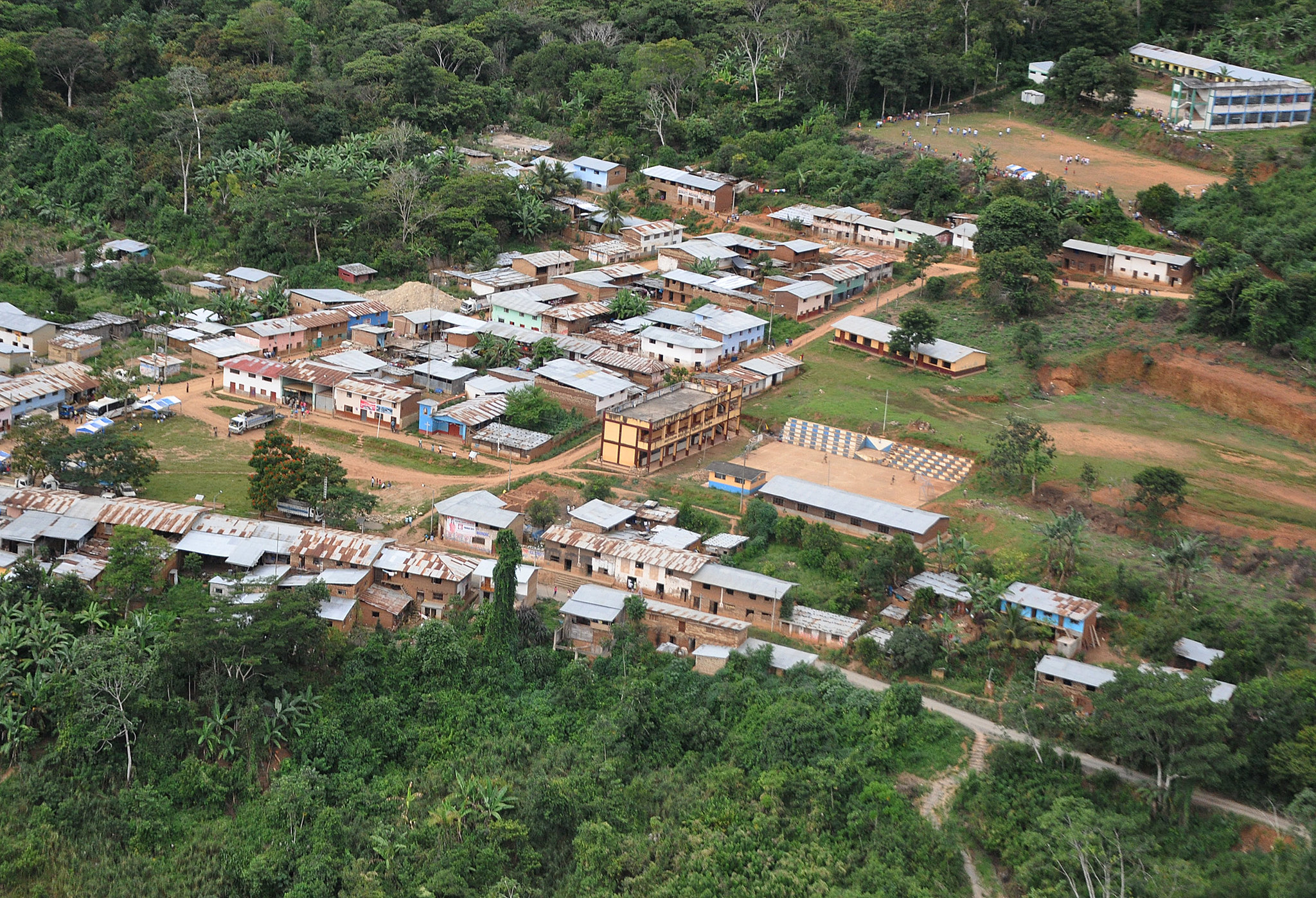 Aerial view of village nestled in lush jungle