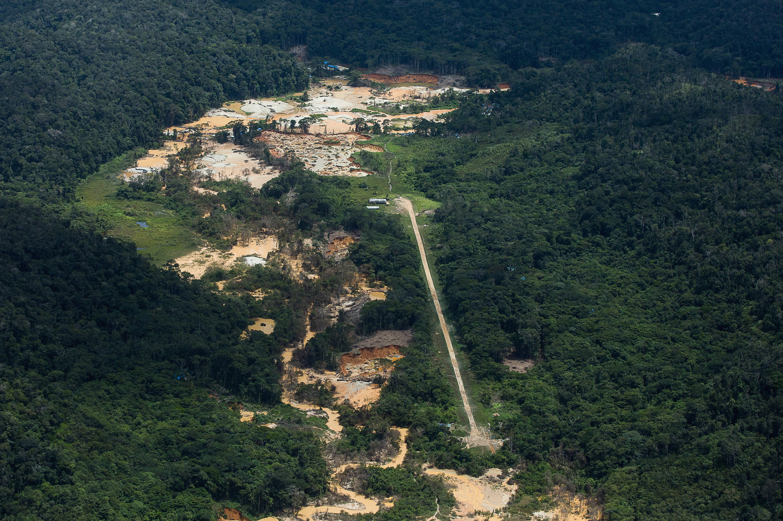 <p>A dirt runway near an illegal mining site in the Yanomami Indigenous territory, Roraima state, Brazil. In this remote region of the Amazon rainforest, where road and river access is limited, prospectors mainly use aircraft to get around (Image: <a href="https://flic.kr/p/2m7kdUn">Bruno Kelly</a> / <a href="https://www.flickr.com/people/amazoniareal/">Amazônia Real</a>, <a href="https://creativecommons.org/licenses/by-nc-sa/2.0/">CC BY-NC-SA</a>)</p>