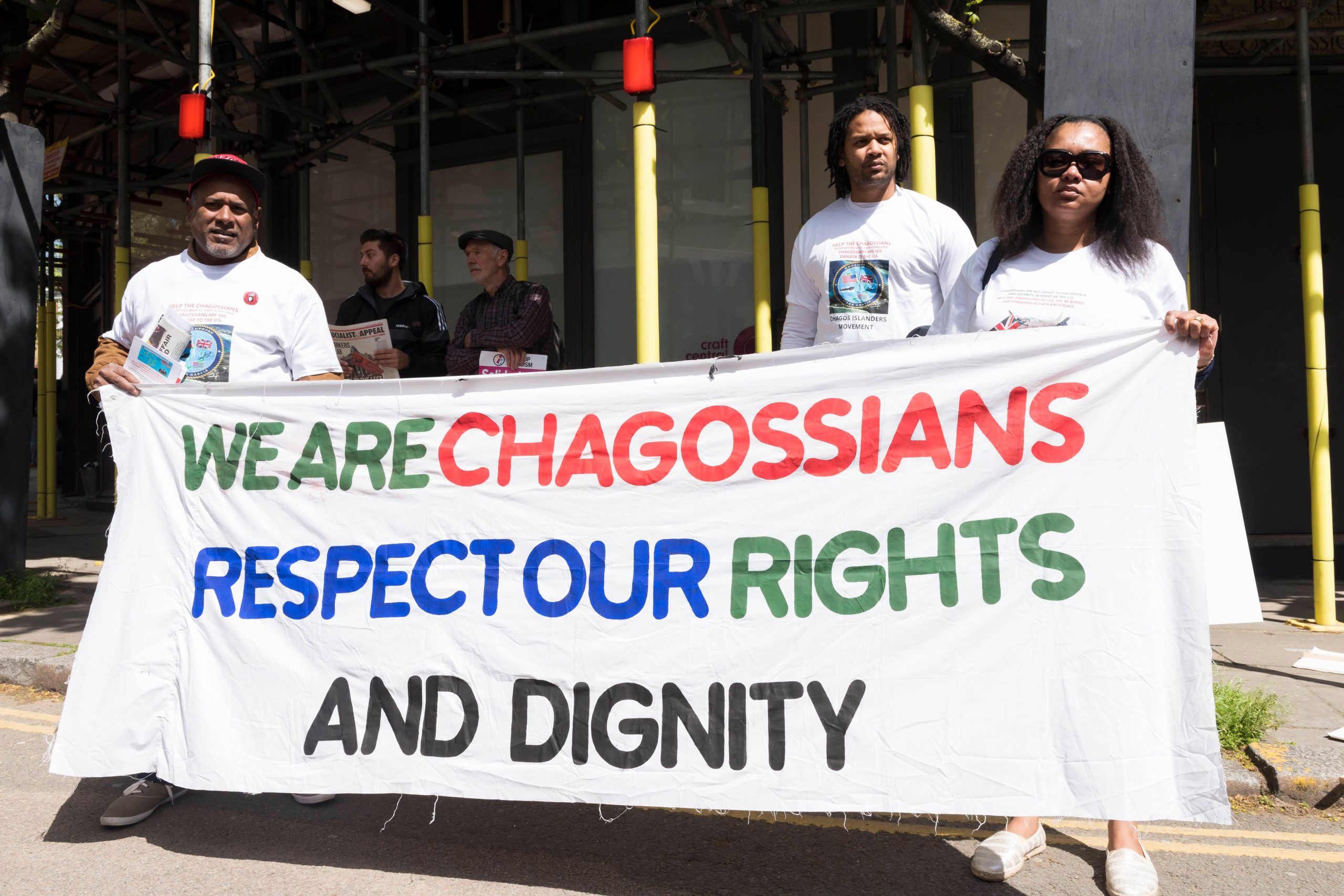 People holding up banner