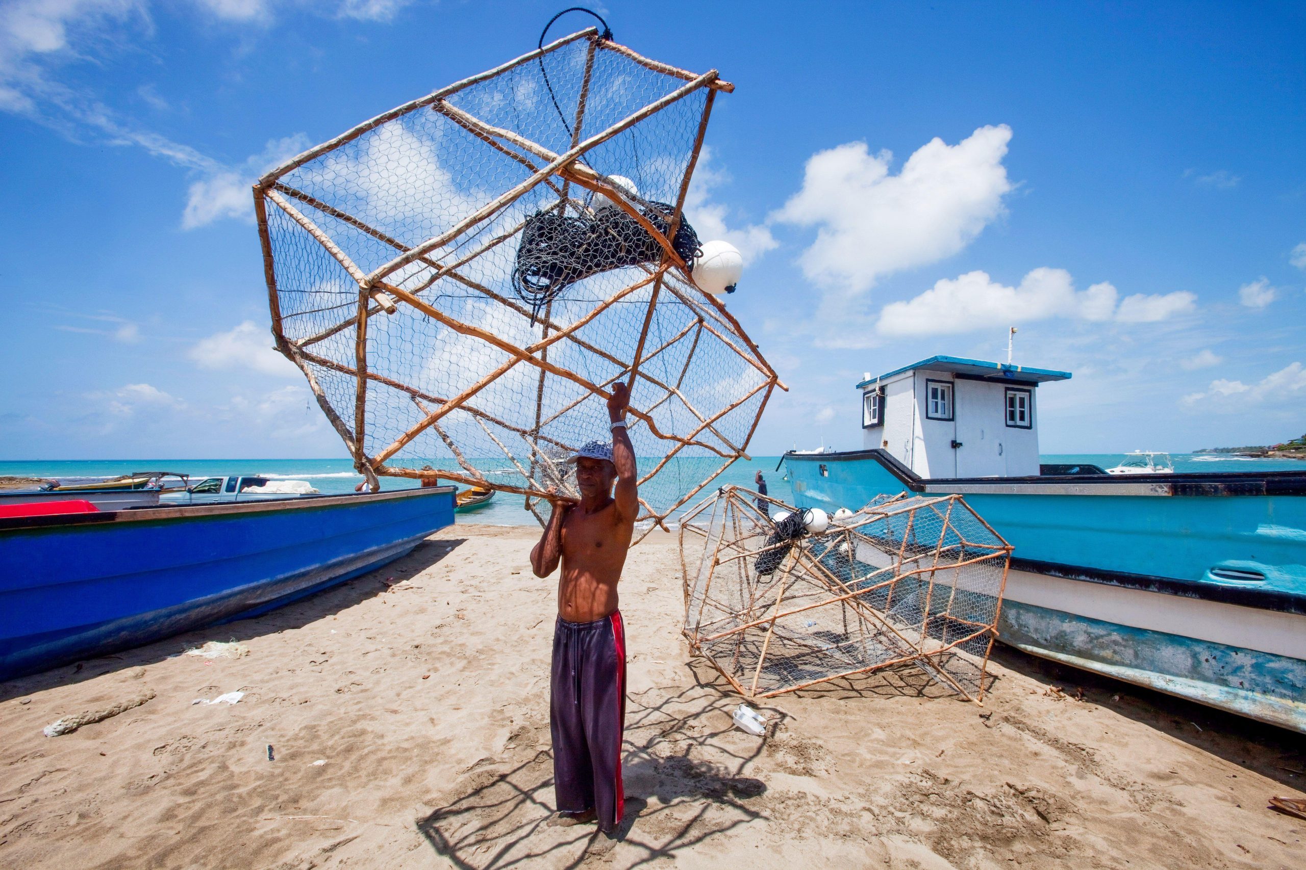 <p>A fisher on a beach in southern Jamaica. Countries like it could benefit from the loss and damage fund, which aims to offer compensation for harm incurred from climate change, but experts fear calculating claims may prove challenging (Image: Ron Giling / Alamy)</p>
<p>&nbsp;</p>