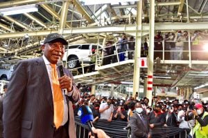 Cyril Ramaphosa holding microphones before large crowd