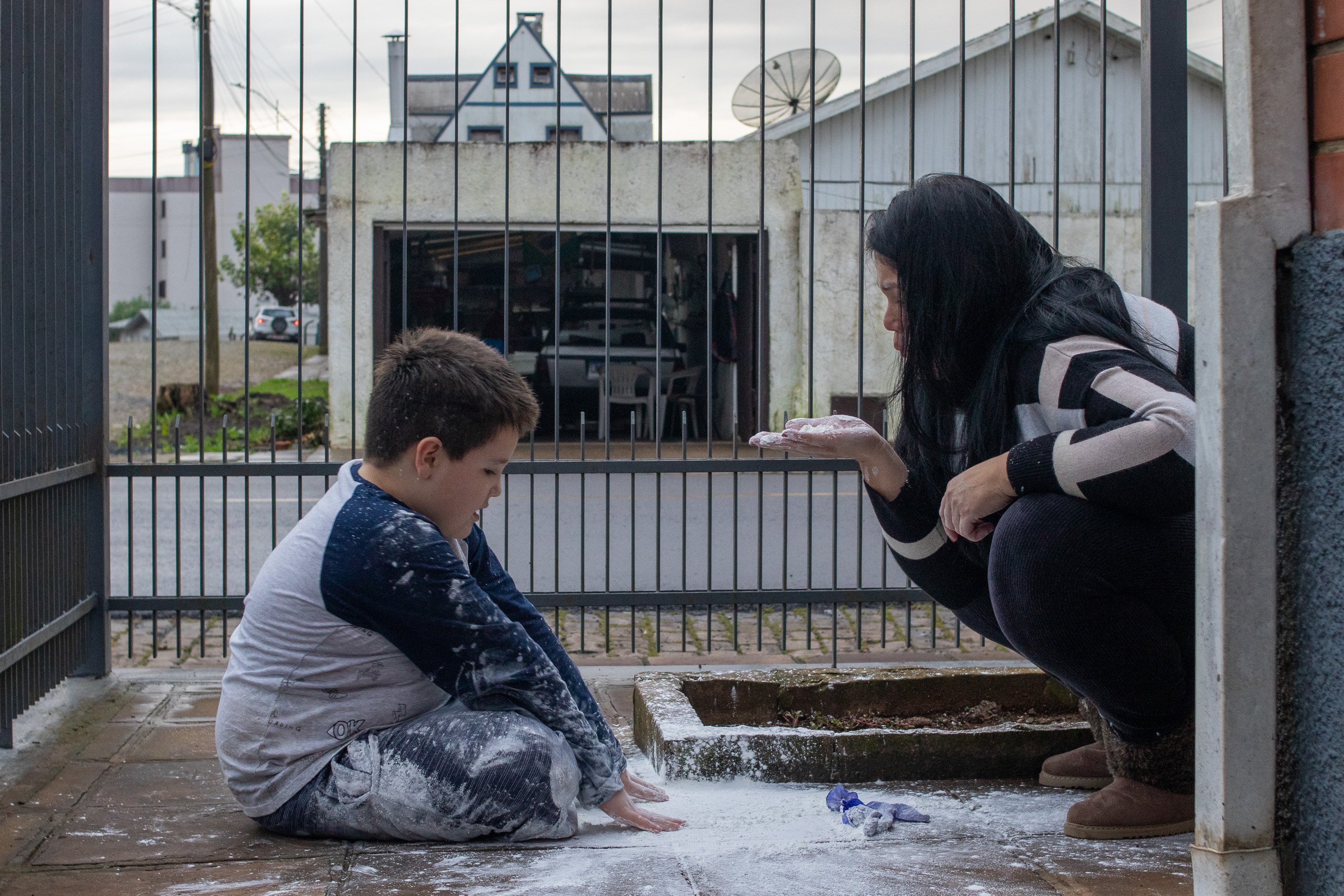 woman and boy playing with white powder